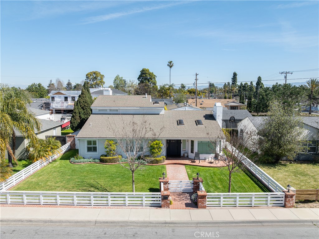 Located on one of Eastside Costa Mesa’s most desirable interior streets, this inviting property on the 400 block of Magnolia blends timeless curb appeal with versatile living space and a prime Mariners Elementary location. Behind the classic white picket fence, the main residence offers 4 bedrooms, 2.5 baths, and 2,537 square feet of thoughtfully designed living space. Vaulted ceilings and warm wood floors create an open, airy feel, while French doors connect the living spaces to a spacious backyard designed for year-round entertaining. The main floor features three bedrooms, while the second floor has the main primary suite.
Out back, you'll find a resort-style pool and spa, a cozy fire pit, and alley access to a generous two-car garage. Off of the garage, a separate 690-square-foot guest house provides even more flexibility with a large bedroom/living area and full bath — ideal for guests, a home office, or extended family.
With its unbeatable location, classic Eastside charm, and move-in-ready layout, this home is the full package.