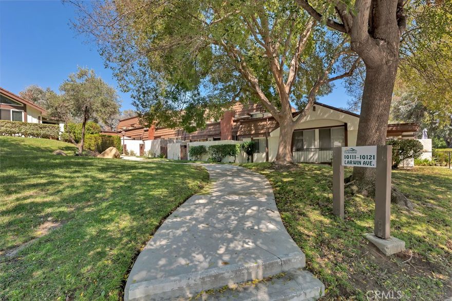 Welcome to this beautifully renovated 4 bedroom, 3 bathroom townhouse offering 2,008 sqft of stylish living in the highly desirable Rockpointe Community of Chatsworth. Thoughtfully updated, the home features luxury laminate flooring, recessed lighting, dual-pane windows, updated bathrooms, and even a finished garage. Step inside to an inviting open floor plan where the bright split-level living room impresses with soaring vaulted ceilings, a cozy fireplace, and abundant natural light. Just a few steps up, the dining room with a wet bar makes entertaining seamless, while the centrally located kitchen provides plenty of cabinet space, a center island, all appliances, and a hanging pot rack. A comfortable family room and nearby half bath offer the perfect space for more intimate gatherings. Upstairs, the spacious primary suite includes a new custom walk-in closet with built-in drawers and cabinets, and an updated ensuite featuring new tile flooring, a modern walk-in shower, and a new toilet. Three additional guest bedrooms with ceiling fans and generous closets share a refreshed bathroom complete with a new dual vanity, new tile flooring, a new toilet, and updated shower features. Outdoor living is equally appealing with a welcoming front patio and a trellis-covered back patio—perfect for dining al fresco or creating your own outdoor retreat. Set across 92 acres with over 3,000 mature trees, Rockpointe offers a serene setting and resort-style amenities including 4 swimming pools, a clubhouse, kitchen and BBQ facilities, multiple playgrounds, and easy access to Chatsworth Park North & South as well as the hiking trails of Santa Susana State Park.