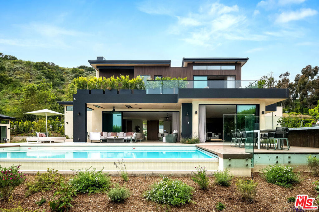 Welcome to Malibu Colony Estates on one of Malibu's most sought-after streets, Malibu Road. This brand new construction warm Contemporary compound sits behind double gates on just over an acre and is surrounded by some of Malibu's most prestigious beach homes and the Pacific Ocean. Extremely private and just a stone's throw from the Malibu Country Mart this home is conveniently located for you to enjoy the safety and privacy of a small gated community with access to the best food and shopping that Malibu has to offer! This one-of-a-kind architectural compound features 6 bedrooms, 8 bathrooms with 7,334 sq ft of luxurious living space. This home has been built with the most high-end construction and finished with the finest materials that were hand-picked and imported from Italy. Upon entering through a beautiful oversized custom wood pivot door you are immediately greeted by the feeling of a warm yet grand modern beach house with a huge yard and stunning exterior views. The open floor plan consists of a perfect balance of indoor/outdoor flow overlooking the infinity pool, spa, and ocean views. Poliform cabinetry, Miele appliances and a porcelain center island complete the kitchen with all top-of -the-line materials and appliances. The grand living and dining rooms sit adjacent to the kitchen allowing the perfect space for family gatherings or entertaining. The primary suite includes a small bar, a private balcony, custom-made Poliform walk-in wardrobe and breathtaking ocean views. The floor-to-ceiling neolith slabs in the primary bathroom engulf you in true Italian opulence. The serene primary bathroom consists of a double sink, grand tub and a large open shower all finished in Cea plumbing. This lower level features a media room with a pool table and private bar completed with state-of-the-art furniture from Minotti, Molteni, B&B Italia and Bonaldo, which are available to be sold with the property. The outdoor living space is truly amazing featuring a huge grassy backyard, guest house, a 45x22 infinity-edge pool with an outdoor BBQ, dining area and private seating area from renowned brands Kettal and Roda.