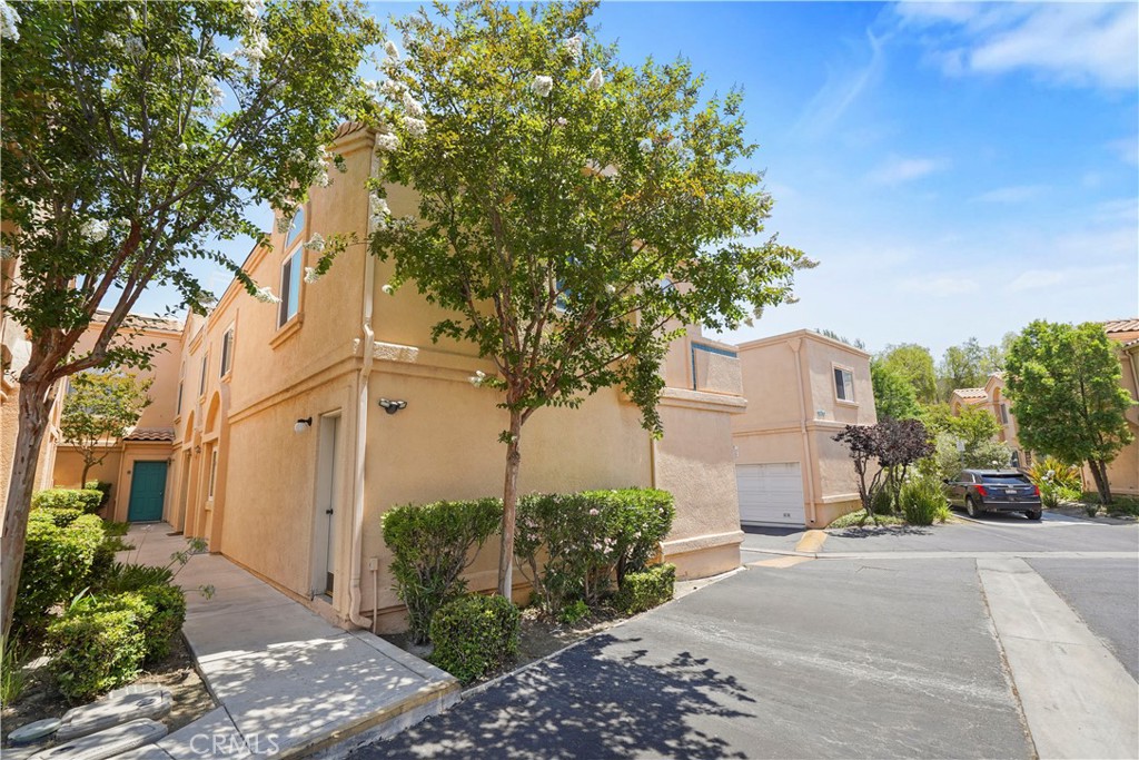 We invite you to this lovely 2 bedroom/1 bath townhome that has been meticulously refurbished & ready for your move in. This light filled corner unit has brand new carpeting throughout, central air & heat, newer Milgard double pane windows & slider, new window treatments, ceiling fans in both bedrooms & dining area and a fireplace in the living room. The kitchen is equipped with all the stainless-steel appliances, recessed lighting, plenty of cabinets & granite counter space. The primary bedroom has a walk-in closet & the hallway bathroom has dual sinks & mirrors, modern fixtures including a rain shower head with a handheld sprayer and a brand new shower door. The flooring on the attached garage has been newly epoxied and houses the washer & dryer. Located in a very well maintained complex with secured access & nightly patrol security, ample guest parking, community pool & spa & more importantly the water, trash & earthquake insurance are all included in the monthly HOA. Walking distance to Costco, Stater Bros supermarket, restaurants & shops and very easy access to the freeway. This is a great starter home. A must-see!