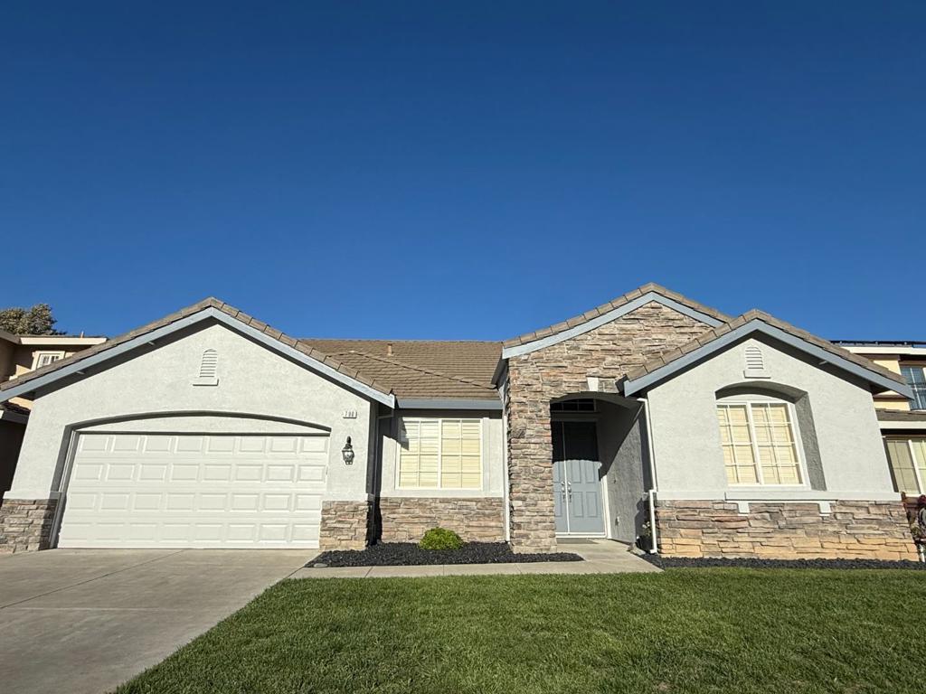 Welcome to this spacious home in Tracy, offering 2,561 sq ft of well-designed living space. The property features three generously-sized bedrooms, 2 additional rooms (bonus/hobby room or den) including a primary bedroom on the ground floor with a walk-in closet. Enjoy the convenience of double sinks and a sunken tub in the primary bathroom, along with additional full and half bath facilities on the ground floor. The kitchen is newly painted, equipped with Energy Star appliances, a gas cooktop, built-in ovens, microwave, and an island with sink. It seamlessly connects to the family room, creating a warm, inviting environment for gatherings. The living and dining areas offer versatility with a breakfast nook and dining area in the living room. This home boasts a mix of carpet, hardwood, tile, and vinyl flooring, adding both comfort and style. A cozy fireplace enhances the living area ambiance. For laundry, enjoy the convenience of inside hookups supporting both 220V electricity and gas. This property falls within the Tracy Joint Unified Elementary School District. Additional amenities include central AC, ceiling fans, solar power, and a garage with EV Level 2 hookups. Make this Tracy gem your own!