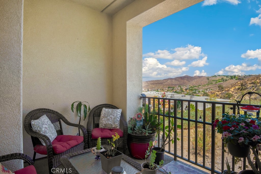 ***VIEW***VIEW***VIEW*** Rare Corner Unit with Amazing Views in Lake Elsinore! One of the few highly sought-after corner units, this updated 2 bed, 2 bath home offers incredible natural light, an open floorplan, and modern upgrades throughout. Enjoy newer LVP flooring, tile, and a remodeled kitchen featuring a stylish tiled backsplash, bar seating, and plenty of counter space. The inviting living room boasts a cozy fireplace and flows seamlessly into the dining area. The spacious primary suite includes a walk-in closet and en suite bathroom, while the second bedroom and bathroom provide flexibility for guests or a home office. Additional features include an attached 1-car garage and in-unit laundry for convenience. Located in an FHA-approved building, this community offers fantastic amenities including a sparkling pool, relaxing spa, and guest parking. Perfectly situated near Lake Elsinore, shopping, dining, and with easy freeway access, this is the ideal home!