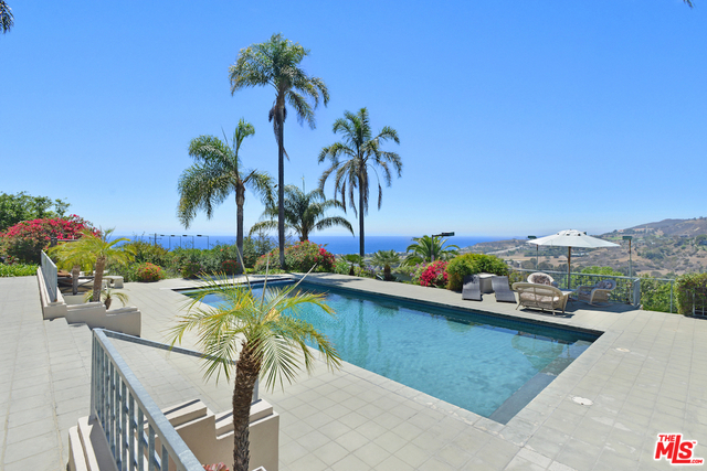 A rare property gem is available on Sweetwater Mesa overlooking the expanse from Malibu Civic Center to Point Dume and beyond. Situated on approx. 2.1 acres, this unique estate home features high ceilings, a well-designed floor plan, guest quarters w/ separate entrance, and dramatic ocean views from almost every room. There is a large swimming pool and spa surrounded by decks, a north/south lighted tennis court, a barn / storage building, and ample space for parking cars when entertaining. The grounds are lushly landscaped for privacy and include a mature fruit orchard, raised vegetable beds, an extensive lawn, and large rose garden. The home has a gated entrance, 5-car garage with a circular driveway, a chauffeurs room with separate entrance, and a large ocean view office. Located in 24 hour guard gated Serra Retreat, this home offers exceptional security and seclusion while still being close by to the shops and restaurants of central Malibu
