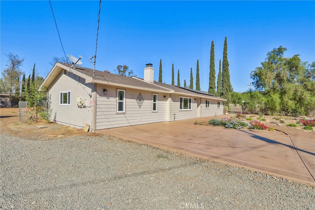 Welcome to this beautifully remodeled home in Ramona, where no expense was spared. Freshly painted inside and out using Sherwin Williams paint, this residence features new ceiling fans, CAT5 cabling for all your networking needs, and new LED recessed lighting. Enjoy a surround sound system with ceiling speakers, solid surface counters and window sills, and a luxurious marble master bath with heated flooring and three shower heads. The hallway bathroom has also been tastefully updated.
The garage has been professionally converted into a family and media room, complete with a recessed floor outlet and stunning colored, polished flooring. The kitchen is equipped with stainless steel appliances, a ceramic cooktop, a new stainless steel vented hood, a moveable kitchen island, and a charming garden window. The updated laundry and utility room is plumbed for a sink, adding extra convenience.
Step outside to an expansive fully fenced backyard featuring a metal shed, a 10x14 foot slab ready for a shop/or shed, a covered patio with misters, stamped concrete, and a propane firepit—ideal for entertaining. The yard also has two drive through 12 foot gates. The front of the home boasts a large 6-inch steel-reinforced, colored, and stamped concrete driveway with sidewalks and newly installed waterwise landscaping. Additional highlights include a newer roof with transferable warranty, paid solar, RV parking with a 50 Amp panel, an owned propane tank, a backyard sprinkler system, as well as front and backyard drip irrigation all on timers. There is a view of the hills from the front of the home, and the location could not be more ideal as it is located on a private quiet road.