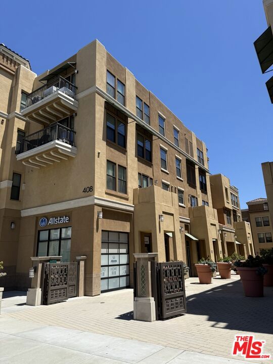 New Price! Built in 2012, this well-maintained modern condo offers 2 spacious bedrooms and 2 full bathrooms across 1,070 sq ft of open-concept living. The bright and airy layout features recessed lighting, a stackable washer and dryer, and a sleek kitchen equipped with stainless steel appliances including a newer dishwasher (installed in 2024). The primary suite includes an ensuite bath and multiple closets, providing comfort and convenience. Recent upgrades include brass water heater pipes and a full system flush in recent years, ensuring peace of mind. Enjoy community amenities that include a beautifully landscaped garden area with a BBQ grill, outdoor dining space with stools, a cozy fireplace seating area with cushioned benches, and a lush grass area for relaxation. Additional highlights include two assigned parking spaces in a secure gated garage. Ideally located just minutes from markets, renowned restaurants, parks, a golf course, schools, and with easy access to freeways 710 and 10this home combines style, comfort, and convenience.
