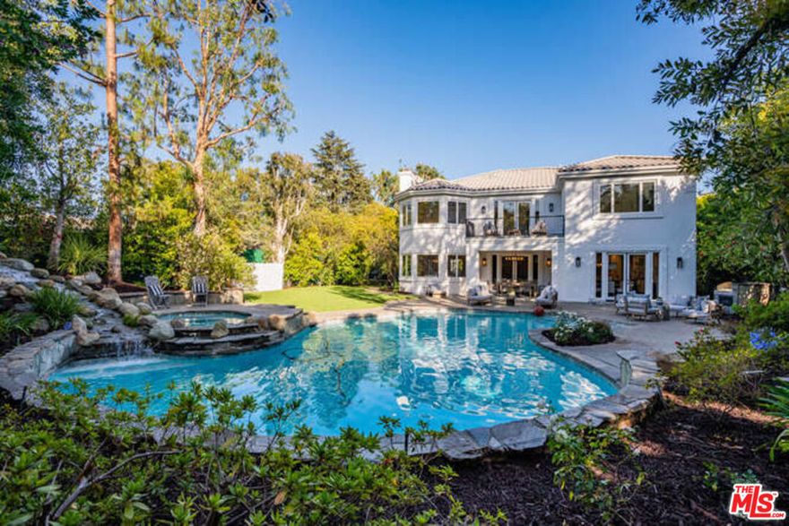 Beautifully and extensively remodeled and renovated throughout, this stunning residence shows like new. Grand two-story foyer, flooded with natural light, opens onto the formal living room with fireplace and sitting room, with French doors which open to a charming private garden with fountain. The spacious open concept kitchen and family room feature a huge center island with dining bar, dual dishwashers, farmhouse sink, marble slab countertops, 300 bottle wine refrigerator and beverage center, ample storage and pantry plus an intimate junior dining area. The formal dining room is lovely with views out to the lush and private back yard. A bedroom suite, power room and gym/bonus room complete the downstairs. The primary bedroom suite is a retreat unto itself with a fireplace, cozy sitting area, large balcony, huge walk-in closet and an incredible spa-like primary bath with heated marble floors, dual vanities and make up area, large soaking tub and deluxe shower with separate steam room. There are also three additional secondary bedroom suites upstairs plus a roomy and comfortable lounge area, perfect for a study or upstairs family room. The backyard is like a 5-starhotel, with sparkling lagoon pool with spa and waterfall, large grassy area, built-in outdoor barbeque kitchen and heated dining veranda off the kitchen and family room. Smart home features enable one to control home systems and pool from one's phone. Attached two-car garage with 240/50 Amp outlet for electric vehicles offers direct access to the residence. The grounds are gated and private with a large grassy front yard and off-street parking for multiple vehicles. Located in a prestigious N. of Sunset location, close to fine dining, shops and the best of Brentwood, this property is not to be missed. Site & Floor Plan can be viewed in DOCS.