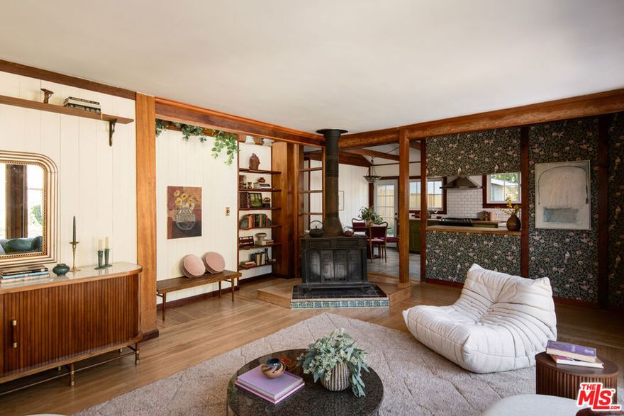 301 Museum Dr is a home for the curious, the contemplative, and the creative, with endless details that lend themselves to daily discovery and inspiration. This quintessential Mid-Century cabin feels imbued with that specific Mount Washington soul, the result of different owners over the decades layering on their own warmth and style, creating an effortlessly charming retreat rich with character and history. Original wood details abound, and quaint built-ins and nooks make for serene moments throughout the home. Large picture windows and a collection of skylights flood both floors with natural light, and patios from the kitchen and primary bedroom provide a casual indoor-outdoor flow. The kitchen and dining area have been opened up and completely redesigned with an intuitive layout and an inviting palette. Upstairs, two spacious bedrooms gaze out at the lush, terraced yard. The subtle-toned upstairs bath includes a secret portal (behind the full length mirror) to a significant space for added storage. The current owners have made many improvements to the home, including a new roof, new windows, new doors, and fully renovated kitchen and baths; a full list of updates is available upon request. Located just north of the Southwest Museum, 301 Museum Dr offers the benefit of Mount Washington's tranquil landscape along with quick proximity to Fig, York, the Metro, Moon Canyon Park, the Self-Realization Fellowship, and of course Mt Washington Elementary.