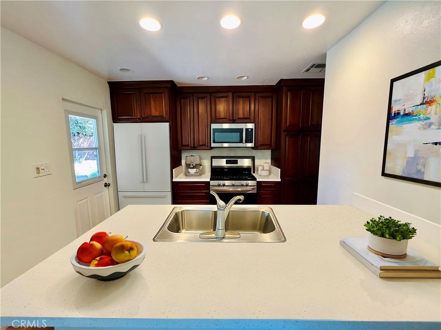 Welcome to 22901 Leadwell Street, a beautifully updated home nestled on a peaceful tree-lined street in the heart of West Hills. This light-filled residence blends modern comfort with classic California charm, offering spacious living areas, stylish finishes, and a private backyard perfect for relaxing or entertaining. Step inside to find an inviting living room with large picture windows that flood the space with natural light. The recently upgraded kitchen features quartz countertops, shaker-style cabinetry, stainless steel appliances, and an open flow into the dining area—ideal for both everyday living and hosting gatherings. The home offers generous bedrooms with ample closet space and beautifully refreshed bathrooms with contemporary fixtures. Outside, enjoy your own private retreat with a large patio, mature landscaping, and plenty of room for outdoor dining or play. Additional highlights include newer flooring, recessed lighting, central air and heat, and a convenient attached garage. Located within a sought-after pocket of West Hills, you’re minutes from top-rated schools, shopping, dining, and scenic parks. This home perfectly captures the relaxed yet refined Southern California lifestyle—ready for you to move right in and start your next chapter. Gardening service included in the rent.