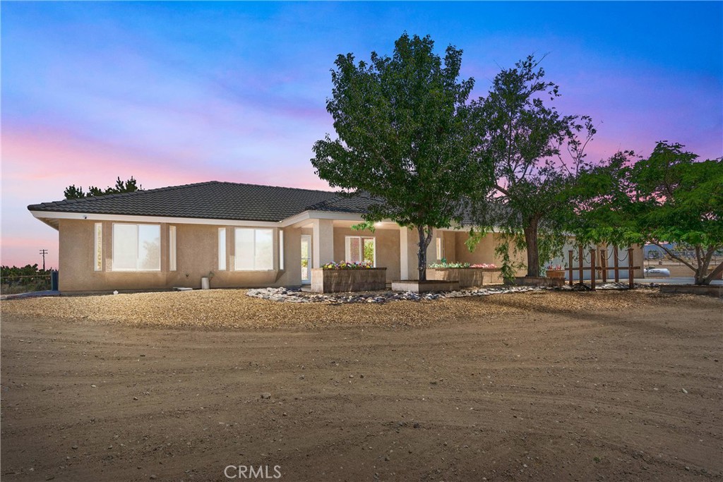 **APPRAISED VALUE $625,000.00** ALL INSPECTIONS COMPLETED** IMMACULATE HOME ready for the new buyers Just 330 Ft from Pavement with Mountain Views, RV Garage & Turnkey Perks!
This beautifully upgraded home sits just 330 feet off the paved road, offering the perfect blend of comfort, functionality all on a spacious 0.76-acre lot with stunning desert and mountain views.
One of the standout features is the separate 48’L x 16’W RV garage, built with a high red I-beam, two roll-up doors, and a walk-through access door, ideal for storing RVs, boats, toys, or creating the ultimate workshop!
Inside the main home, you’ll find 4 bedrooms, 3.75 bathrooms, plus a bonus room with double French doors, perfect for a private office, game room, or flex space. One of the bedrooms includes its own private ensuite with bathroom and shower—great for guests, teens, or multi-gen living.
The oversized 3-car garage includes direct access to a ¾ “man’s shower/toilet area”, perfect for cleanup before entering the home. The interior layout is open and warm, with gorgeous wood flooring throughout. The kitchen is a true showstopper, featuring granite countertops, a walk-in pantry, and a stunning open layout hexagon-shaped island that’s as functional as it is beautiful, ideal for entertaining, cooking, or casual dining.
Additional upgrades include: Custom landscaping with raised cement/block planter beds and irrigation. Brick-inlay walkways and a charming covered front porch with a decorative bridge and water fountain. Covered back patio, fenced and cross-fenced yard with large electric gate. Wood-burning stove with custom stone/tile hearth. Ceiling fans, laminated flooring, and professional window tinting for added energy efficiency. Indoor laundry room with extra storage. Water softener and water filtration system. High-end HD security system, professionally hardwired throughout the home and property (included!)
Located just minutes from schools, shopping, and downtown access. This home offers space, privacy, and unmatched functionality with room for all your vehicles, toys, and tools.
Don’t miss this rare opportunity to own a truly turnkey property in a prime High Desert location!