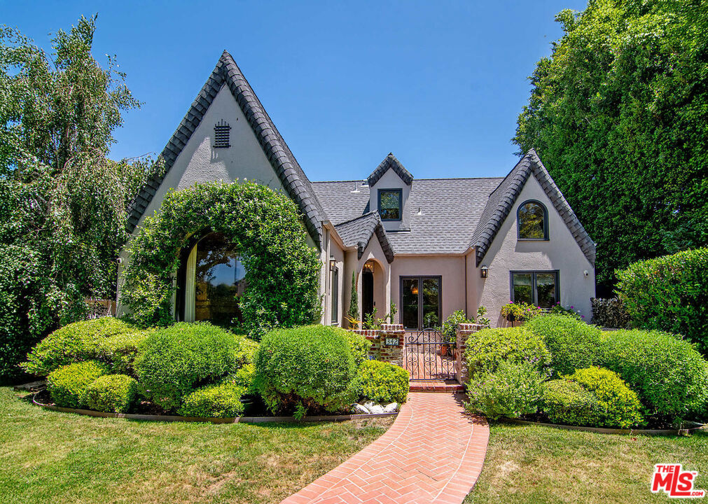 342 N Citrus is a timeless English Tudor masterfully reimagined with a fresh, design-forward aesthetic. Nestled on a picturesque, tree-lined street in the heart of Hancock Park, this 6-bedroom, 5-bathroom home blends the romantic charm with architecture with the comfort and convenience of modern living. Gated and hedged for privacy, the front patio offers an ideal space for entertaining. Step through the stunning mosaic Pinky's wrought-iron door and into a living room with soaring vaulted ceilings and a breathtaking picture window that instantly captures attention. The heart of the home is a beautifully curated kitchen featuring a center island with and a cozy breakfast nook the perfect gathering place. Every space has been thoughtfully designed and the entire home was taken down to the studs in 2021. The super-sized primary suite stuns with pitched ceilings, an expansive spa-like bathroom, and hand-painted wallpaper. The secondary bedrooms are equally impressive, offering comfort, scale, and style. The detached designer-done ADU (6th bedroom) adds flexibility ideal for guests, office, or income. To name a few of the modern upgrades home includes 3-zone central AC, smart switches, updated systems, automated blackout shades on skylight windows, and lots of built-in storage. This home is truly move-in ready and it's hard to find a finished home with this exceptional level of taste and quality. Located on one of the most desirable blocks in Hancock Park, it's a rare opportunity to own a showpiece with soul.