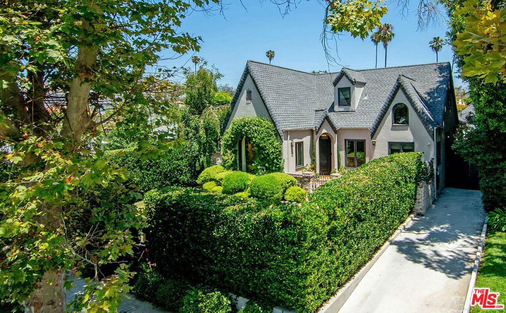 342 N Citrus is a timeless English Tudor masterfully reimagined with a fresh, design-forward aesthetic. Nestled on a picturesque, tree-lined street in the heart of Hancock Park, this 6-bedroom, 5-bathroom home blends the romantic charm with architecture with the comfort and convenience of modern living. Gated and hedged for privacy, the front patio offers an ideal space for entertaining. Step through the stunning mosaic Pinky's wrought-iron door and into a living room with soaring vaulted ceilings and a breathtaking picture window that instantly captures attention. The heart of the home is a beautifully curated kitchen featuring a center island with and a cozy breakfast nook the perfect gathering place. Every space has been thoughtfully designed and the entire home was taken down to the studs in 2021. The super-sized primary suite stuns with pitched ceilings, an expansive spa-like bathroom, and hand-painted wallpaper. The secondary bedrooms are equally impressive, offering comfort, scale, and style. The detached designer-done ADU (6th bedroom) adds flexibility ideal for guests, office, or income. To name a few of the modern upgrades home includes 3-zone central AC, smart switches, updated systems, automated blackout shades on skylight windows, and lots of built-in storage. This home is truly move-in ready and it's hard to find a finished home with this exceptional level of taste and quality. Located on one of the most desirable blocks in Hancock Park, it's a rare opportunity to own a showpiece with soul.