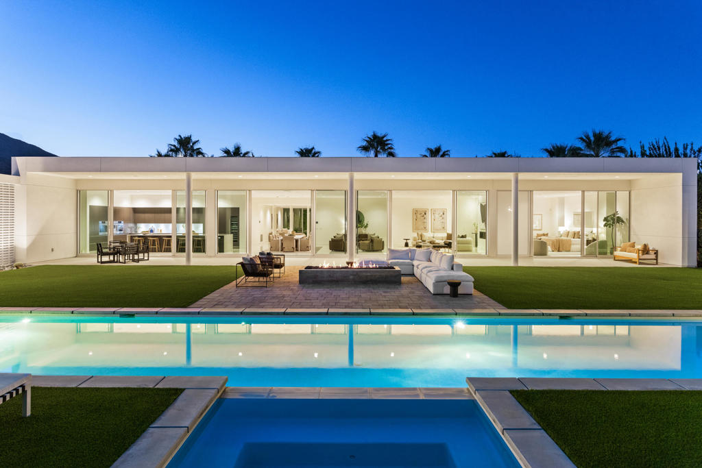 Rare offering of an exceptional home just in time for season. 3088 Linea Terrace features minimalist architecture with an artist's attention to visual rhythm, massing and scale. Anchored by a 90-foot expanse of oversized Fleetwood glass sliders facing a 60-foot lap pool, the proportions are grand and harmonious. Linea is an exceptional neighborhood - 14 all white modern homes sited for maximum privacy. 3088 Linea Terrace has perhaps the best street presence - elevated lot, stunning colonnade -- and features the award-winning G floor plan. The soul of this home is its simplicity. The design is clean and bold, the spaces expansive, the landscape low-maintenance. The setting in Andreas Hills is epic, just minutes from central Palm Springs, nestled between mountains on all sides. Four bedrooms and five baths. The main house features the primary suite and two well-separated guest suites, as well as a dedicated media room. The attached one-bedroom casita has its own street entrance. Linea has its own private gate but the HOAs are very low, and you own the land. Three-car garage, fully owned solar, pergola with outdoor kitchen (including wet bar, grill and refrigerator), outdoor shower, covered patio with misters, enormous steam shower in primary. Built for entertainment or your fortress of solitude, minutes from downtown Palm Springs and all its amenities.