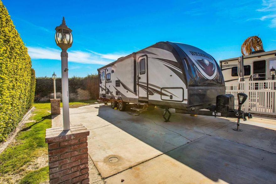 Discover this fantastic starter package in a prime resort location! This beautiful wall lot, conveniently located near La Palma Clubhouse and Satellite C, offers a private retreat with a lush greenbelt behind. Included is a 2018 Heartland Wilderness RV in like-new condition, providing the perfect balance of comfort and style. Whether you're looking for a seasonal escape or a full-time haven, this lot and RV combo is an incredible opportunity to own a piece of resort living. Outdoor Resorts Palm Springs is a Five Star RV Resort Community combining luxury with affordability. It is a guard gated resort that sits on 137 beautifully landscaped acres with 27 holes of executive golf, 10 tennis courts, 13 pickleball courts, 8 swimming pools, a fully equipped fitness center, sports bar, beauty salon/barber shop, full-service restaurant, convenience store, 2 club houses, activities, special events and so much more.