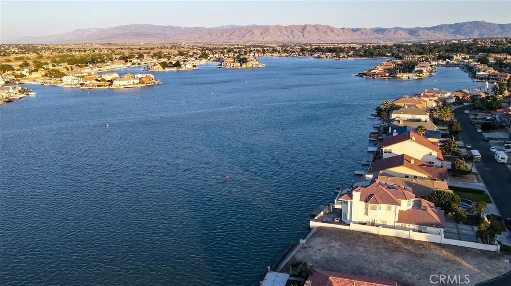 BEST OPEN WATER LAKE FRONT LOT With BREATHTAKING MILLION DOLLAR PANORAMIC SUNRISE VIEWS OVERLOOKING THE OPEN WATER ON THE BEST SIDE OF THE LAKE!!! Build YOUR Own Custom Estate! This is a Unique Lot that YOU Can Have Both SUNRISE & SUNSET VIEWS!!! With a Two Story Home, the Second Story Would Overlook the OPEN WATER and Have SPECTACULAR SUNSET VIEWS On The North Side of The Lot!!! With an Oversized Extra Deep Lot at 10,600 ft.² and 74' of OPEN WATER FRONTAGE there is Plenty of Room To BUILD & EXPERIENCE UNPARALLELED CRAFTSMANSHIP IN YOUR EXQUISITELY DREAM HOME that Could Include a RV Garage, Private Boat Dock, Roof Top, Outdoor Kitchen, Private Swimming Pool and Outdoor Living Area. Located on a Very Quiet Private Cul-De-Sac. There are several Great Builders to choose from. Enjoy the amenities of Spring Valley Lake, Boating, Fishing, Water Skiing, Private Beach, Marina, Multiple Parks and Community Center. Spring Valley Lake is an Oasis in the High Desert! Also available is a Private Golf Course & Country Club with an additional purchased membership. COME SEE AND EXPERIENCE WATERFRONT LIVING WITH MIRACULOUS OPEN WATER VIEWS!!!