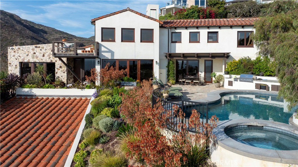 EMERALD BAY | RENTAL | 345 Emerald Bay presents a rare opportunity to lease in this highly sought-after community. Set along the Emerald Bay hillside, this exceptional single-family residence offers seamless indoor/outdoor living with a newly constructed detached Casita suite, private saltwater pool and spa, built-in BBQ, outdoor fireplace, and multiple outdoor lounge and dining terraces—all framing sweeping ocean views.
Inside, the open-concept layout showcases a gourmet kitchen with an island breakfast bar, a separate dining area, inviting family and living rooms, and a beautifully appointed primary suite. The enclosed rear yard features an artificial turf putting green, perfect for relaxed recreation. With dramatic ocean and canyon views, this residence combines privacy, comfort, and luxury in an extraordinary coastal retreat. Lease term negotiable.