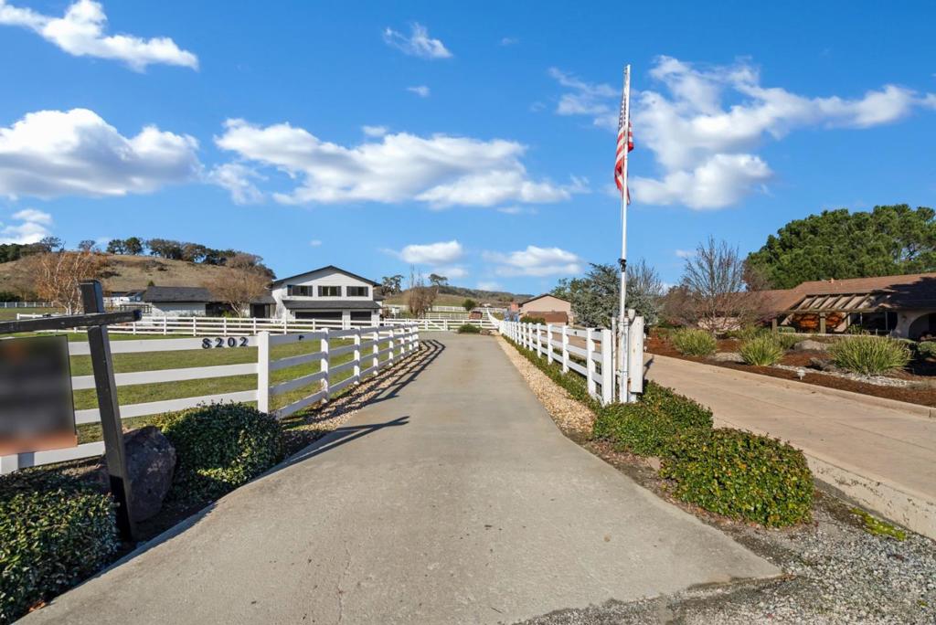 Welcome to your dream retreat nestled in the heart of South County vibrant winery region! This beautifully updated 4 bedroom, 3.5 bathroom home offers a perfect blend of modern comfort and rustic charm, all set on an impressive 3.67 acre lot. As you enter, you will be greeted by an inviting open floor plan that seamlessly integrates the living, dining, and kitchen spaces, ideal for entertaining family and friends. The contemporary kitchen boasts updated appliances, elegant countertops, and ample storage, making it a chefs paradise. Each of the four spacious bedrooms provides ample natural light and comfort, with the master suite featuring a luxurious en-suite bathroom for your private retreat. The additional bathrooms have been tastefully updated, ensuring convenience for your guests and family. Step outside to discover your own slice of paradise! The expansive outdoor space is perfect for gardening, relaxing under the stars, or hosting gatherings. With plenty of room to enjoy the pool and patio area, the opportunities for outdoor activities are endless.