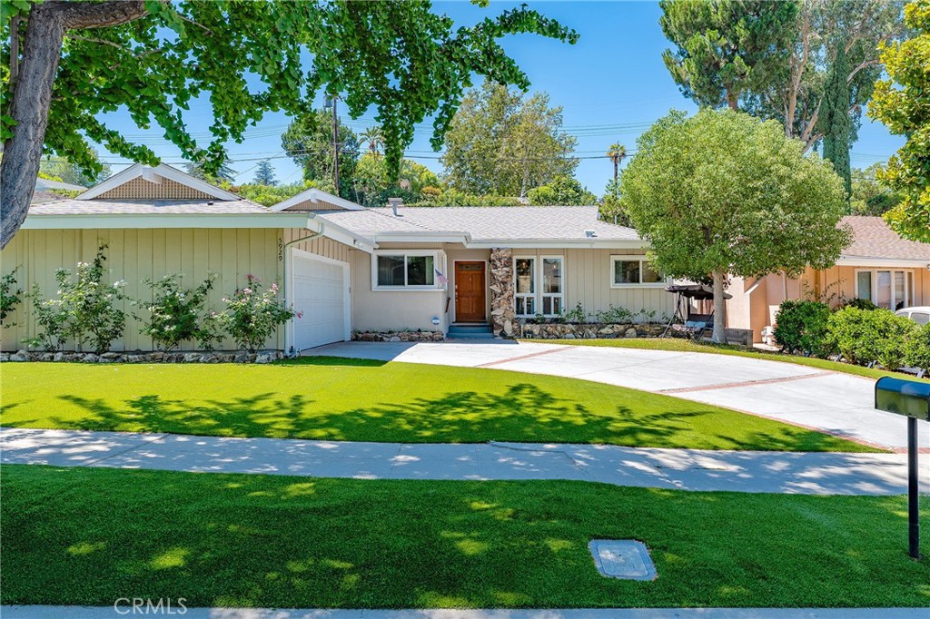 Highly remodeled single story home with paid solar panels! Situated in a great Woodland Hills neighborhood zoned for highly acclaimed Hale and El Camino charter schools. The property has great curb appeal with wide frontage and large front yard with synthetic lawn, mature trees, and sweeping driveway that leads to the 2-car attached garage. Step inside to find a formal entry with coat closet that opens to a sunlit open floor plan featuring new flooring and LED lighting throughout. A spacious living room features modern fireplace flanked by built-in storage shelving and large sliding glass door that opens to the yard. A separate oversized dining room has built-in pantry/storage cabinetry and another sliding glass door that opens to the yard. The gorgeous completely remodeled kitchen opens directly to the living spaces and features quartz counters, custom soft close cabinetry, stainless appliances, pantry space with pullout drawers, large center peninsula with breakfast bar seating, and separate breakfast nook with oversized picture windows. A convenient guest powder bathroom is located off the living spaces. All four bedrooms are located on their own wing of the house. The large primary bedroom is situated perfectly overlooking the backyard with private exterior glass slider, large walk-in closet with built-ins, and en-suite bathroom with walk-in shower and built-in linen storage. The three secondary bedrooms are all well appointed with large windows and good closet space. A large upgraded hall bathroom has new vanity with stone countertop, dual sinks, and bathtub with shower. There is also a separate laundry room off the kitchen with exterior access. The low maintenance backyard features a large covered patio with overhead string lights perfect for outdoor dining, sprawling synesthetic lawn with putting green hole, children’s play set, and producing fruit tree. Additional system upgrades per seller completed in 2022: roof, 200 amp newer electrical panel, tankless water heater, Anderson windows and doors, and owned solar panels for great energy savings! Adjacent to dining/shopping at the Westfield Mall & Village, Calabasas Commons, Warner Center, & great local parks and hiking trails.