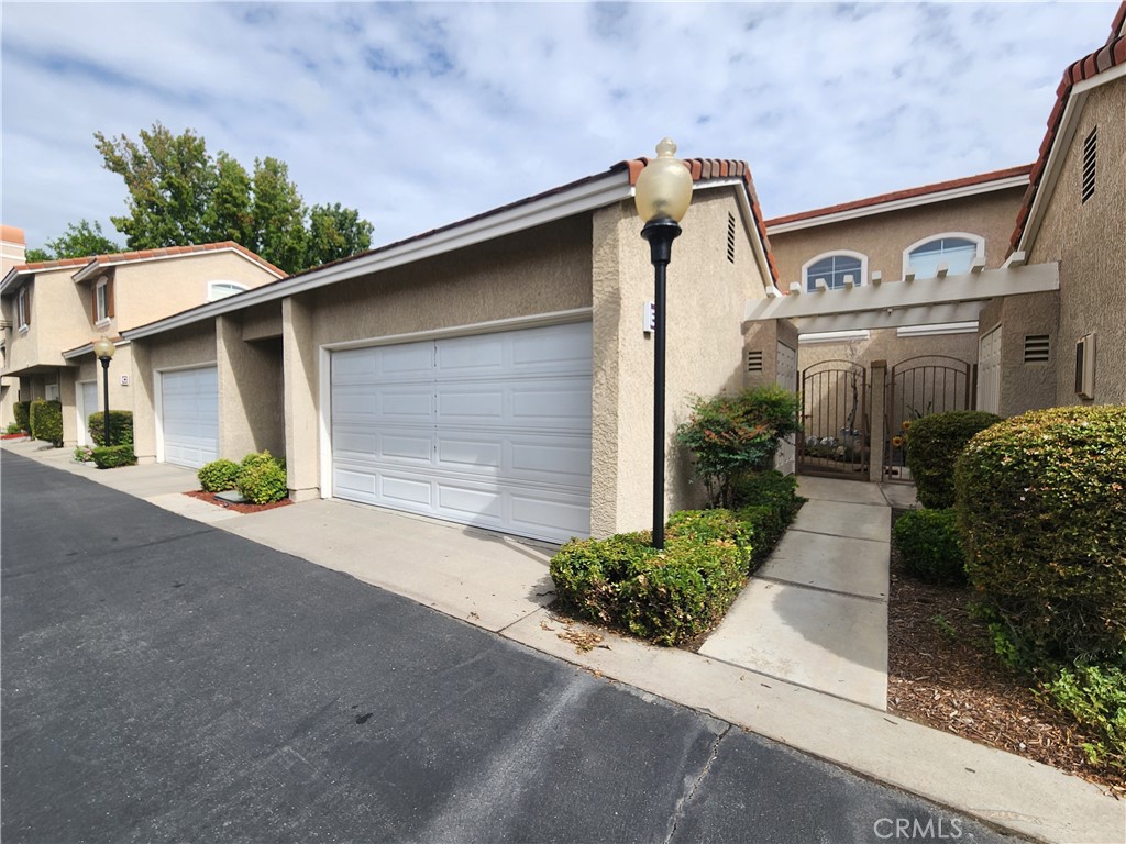 This 3-bedroom, 2.5-bathroom and 2 car attached garage Condo is now available. Wood flooring throughout. Kitchen has tile counter tops, a bar top area perfect for bar stool seating and includes stove-top/oven, microwave and dishwasher appliances. Living room features a decorative fireplace. Convenient half bathroom downstairs. The laundry room includes washer and dryer connections only. The primary bedroom has 2 closets and private bathroom with dual sinks. The other 2 bedrooms are very spacious and offer plenty of closet storage space. Community pool available. This property is located near the 210 freeway, Victoria Gardens, restaurants, grocery stores and many shopping plazas.