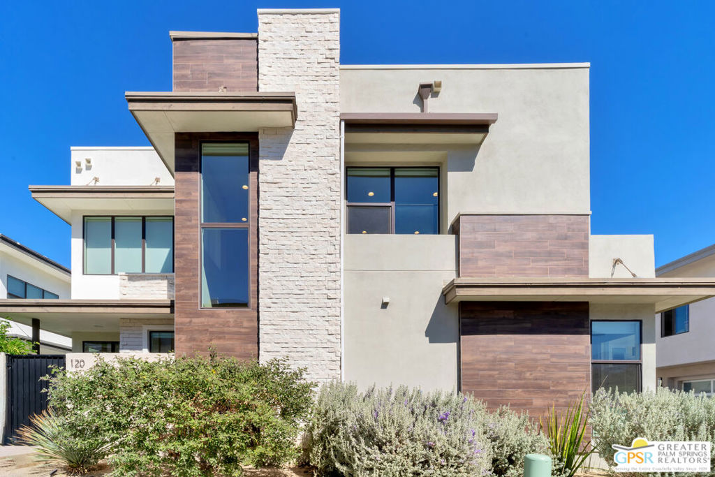 Experience Elevated Desert Living at 120 Vibe Way, Palm Springs. Step into the ultimate expression of modern desert luxury in the sought-after Vibe community. This highly upgraded 3-bedroom, 3-bath residence blends cutting-edge design with comfort and efficiency, all framed by soaring two-story ceilings, abundant natural light, and stunning mountain views. Inside, discover 1,940 sq. ft. of open-concept living, where every detail has been carefully curated. The chef's kitchen shines with extended quartz countertops, custom cabinetry, a four-stage Ecowater filtration system (including filtered ice and water lines), and a full suite of KitchenAid appliances. Designer George Nelson for Herman Miller "Cigar" Bubble Pendant Lights and Kuzco Vega LED lighting add architectural flair, while Hunter Douglas window coverings, including remote-controlled sunshades, ensure both beauty and comfort. The striking steel and stainless-steel cable stairwell anchors the living area and complements the home's contemporary aesthetic. The primary suite is a serene retreat, offering a spa-inspired bathroom and generous closet space. Two guest suites are equally refined, featuring blackout window treatments, semi-frameless glass shower doors, and thoughtful designer touches throughout. Enjoy seamless indoor-outdoor living with your private courtyard oasis, complete with a Tessera cocktail pool and spa, privacy gate, and professional desert landscaping. Whether relaxing under the stars or entertaining friends, this outdoor space is designed for year-round enjoyment. Additional highlights include: Fully owned 22-panel solar system, High-efficiency Maytag washer & dryer, Kohler low-flow toilets, Added custom cabinetry and storage, Remote-controlled ceiling fans in all bedrooms. The Vibe community offers resort-style amenities, including a lap pool, hot tub, bocce courts, BBQ area, clubhouse, and two dog parks, all within minutes of downtown Palm Springs, world-class dining, shopping, golf, casino, and entertainment. Luxury, sustainability, and Palm Springs sophistication converge beautifully at 120 Vibe Way where every upgrade was made with quality and comfort in mind.