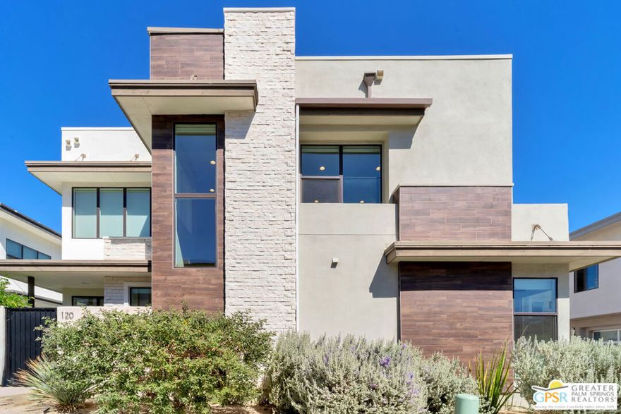 Experience Elevated Desert Living at 120 Vibe Way, Palm Springs. Step into the ultimate expression of modern desert luxury in the sought-after Vibe community. This highly upgraded 3-bedroom, 3-bath residence blends cutting-edge design with comfort and efficiency, all framed by soaring two-story ceilings, abundant natural light, and stunning mountain views. Inside, discover 1,940 sq. ft. of open-concept living, where every detail has been carefully curated. The chef's kitchen shines with extended quartz countertops, custom cabinetry, a four-stage Ecowater filtration system (including filtered ice and water lines), and a full suite of KitchenAid appliances. Designer George Nelson for Herman Miller "Cigar" Bubble Pendant Lights and Kuzco Vega LED lighting add architectural flair, while Hunter Douglas window coverings, including remote-controlled sunshades, ensure both beauty and comfort. The striking steel and stainless-steel cable stairwell anchors the living area and complements the home's contemporary aesthetic. The primary suite is a serene retreat, offering a spa-inspired bathroom and generous closet space. Two guest suites are equally refined, featuring blackout window treatments, semi-frameless glass shower doors, and thoughtful designer touches throughout. Enjoy seamless indoor-outdoor living with your private courtyard oasis, complete with a Tessera cocktail pool and spa, privacy gate, and professional desert landscaping. Whether relaxing under the stars or entertaining friends, this outdoor space is designed for year-round enjoyment. Additional highlights include: Fully owned 22-panel solar system, High-efficiency Maytag washer & dryer, Kohler low-flow toilets, Added custom cabinetry and storage, Remote-controlled ceiling fans in all bedrooms. The Vibe community offers resort-style amenities, including a lap pool, hot tub, bocce courts, BBQ area, clubhouse, and two dog parks, all within minutes of downtown Palm Springs, world-class dining, shopping, golf, casino, and entertainment. Luxury, sustainability, and Palm Springs sophistication converge beautifully at 120 Vibe Way where every upgrade was made with quality and comfort in mind.