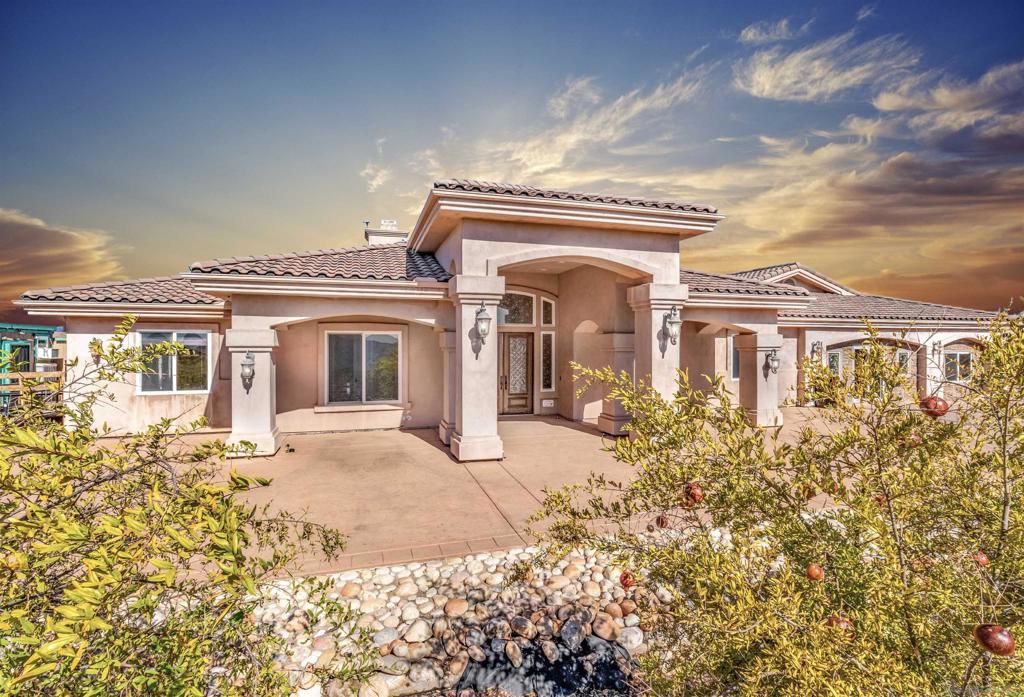 Experience true off-grid luxury on 12.8 acres of breathtaking landscape with panoramic views of mountains and valleys. This 3,212 sq. ft. estate offers complete self-sufficiency with a 14KW solar system with 56 panels, two Tesla Powerwalls, a Generac generator, a 600 ft+ deep private well producing 70 GPM, an 8,500-gallon water tank, whole-house filtration, tankless water heater, and RV hookups with a 50-amp connection. Designed for comfort as well as independence, the home features soaring 10–16 ft. ceilings, crown molding, and an open floor plan filled with natural light. The chef’s kitchen includes brand-new stainless steel appliances installed in August 2024, granite countertops, a pot-filler, and a walk-in pantry. The spacious living room has a gas fireplace and remote blinds, opening seamlessly to the dining area. The primary suite offers a private retreat with a fireplace, dual walk-in closets, spa bath with jetted tub, and oversized shower. Three additional bedrooms include a private guest suite with full bath and separate entrance. A 950 sq. ft. converted garage provides flexible space for a gym, studio, or recreation room. Outdoor living includes 170 mature pomegranate trees, a 12x24 greenhouse, automated irrigation, a detached 24x30 garage, two 50-ft cargo containers, and a workshop with a half bath. With over $140,000 in recent upgrades, this rare estate blends modern luxury with complete sustainability, offering a private sanctuary unlike any other in San Diego County.