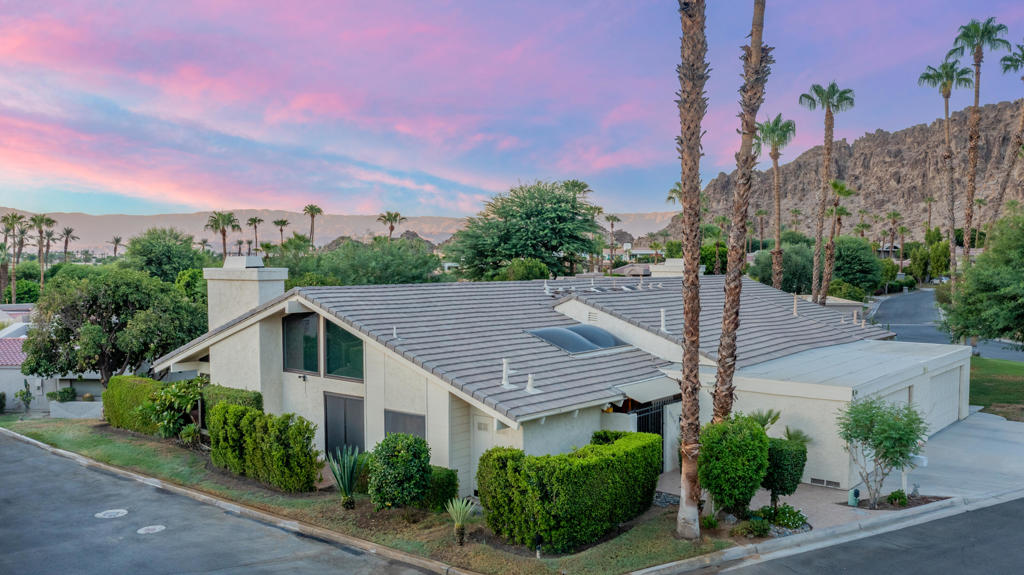 Charming 3-bedroom, 3-bath condo located in the highly sought-after Mountain Cove community in Indian Wells, this beautifully upgraded property offers a serene desert retreat with breathtaking panoramic mountain views. Recent upgrades enhance both the comfort and efficiency of this home, including new dual-pane windows with solar screens on the West-facing side, a new roof installed in 2024, a new water heater, and updated AC condensers. The electrical panel has been upgraded, and the home has new laminate wood flooring and plush carpeting in the guest room. Each bedroom serves as a private master suite, complete with its own en-suite bathroom. The third bedroom has been converted into a den, ideal for indoor-outdoor entertaining, featuring a dry bar with a wine fridge and a newly added walk-in shower. The guest bathroom has an upgraded vanity, while the master bath boasts a stylish walk-in shower, custom tile work on the walls, and an upgraded vanity. The kitchen has been thoughtfully upgraded with a new KitchenAid dishwasher, recessed lighting, granite countertops & backsplash, an expansive island perfect for countertop seating, and a gas stove conversion. Set on a prime corner lot, the condo features elevated views of the surrounding mountains and the renowned Indian Wells Tennis Gardens from its private patio. With one of the lowest HOA & land lease rates in the community, expiring in 2069, this condo presents an incredible opportunity to enjoy low overhead while experiencing easy access to the Indian Wells Country Club, exclusive discounts at nearby golf courses, luxurious spas, fine dining, shopping, and world-class tennis facilities. This property could be an exceptional primary residence, seasonal retreat, or mid-term investment property, that previously rented for $6,000 per month, making it an excellent income-generating opportunity. Call today to set up a tour and explore all the exceptional features this condo has to offer!