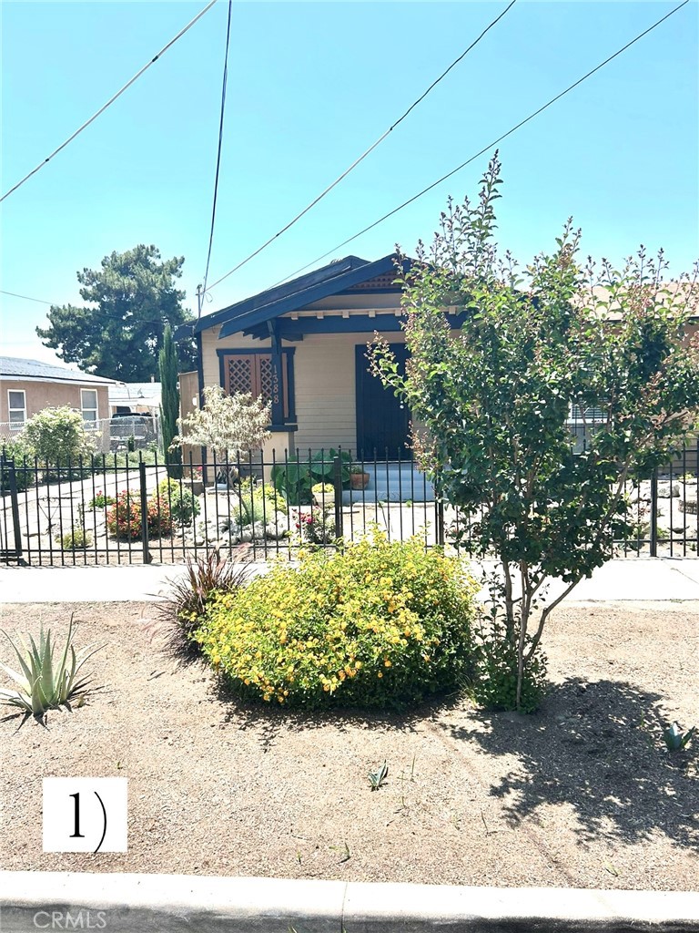 You will simply love this lovely 2 bedroom/1 bath adorable cottage. This property features well-maintained curbside and front-yard landscaping with year-round plants and flowers that enhance its appeal right up to the front door. Upon entering, you will find a beautiful 3-light pendant light, structured over the dining table. A “custom-built window wall” with a sliding door separates and uniquely encloses the living room and TV sitting area, to include custom-fitted window blinds. Desirable sunlight is brought in through the large living room picture window, AND through the window-paned double doors that leads you out to a quaint and relaxing sitting area. The front bedroom closet is charmed with a custom-built barn door, adding special character to this cozy room. Both bedrooms have new ceiling fans. The second bedroom is roomy and has direct access to the bathroom …AND, the bathroom is simply adorable, tiled nicely and designed with a vintage vanity and faucet, and includes added bathroom shelving. The area leading into the kitchen can be set up as additional dining space, or with a desk to function as a comfortable workspace (as set up by the current owner). The kitchen is designed with lovely open upper shelving, and lower cabinet space. Included in this quaint kitchen are attractive wall sconces, installed over both the kitchen sink and second window (just tap the bulbs). The uniquely designed shelving in the laundry room area provides additional storage space. The back door from the laundry room leads right out to the back of the 7750 sq ft property lot, where you will find a well-kept secluded and quiet backyard -- FULLY FENCED. The large yard signals so many opportunities to expand upon; such as building an ADU, a backyard patio, trellis/gazebo and much more – there’s more than enough room !!! The EXTENDED single-car garage provides additional storage space, with a separate backyard door entry, and lighting. The extended driveway also provides room for additional parking. This sweet and adorable home is “ready-to-move-in”, to include: central air/heating, weather efficient dual-pane windows throughout, new water heater, new garbage disposal, stove, refrigerator, washer and dryer.