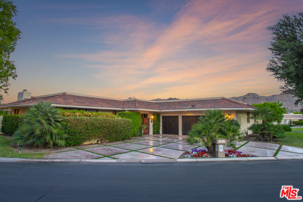 Here is your move-in-ready, chic contemporary retreat in the heart of Rancho Mirage! Set within the prestigious Morningside Country Club community with 24/7 guard-gated access, this sophisticated sanctuary offers nearly 3,300 square feet of spacious, light-filled living. Designed for effortless entertaining, the home features soaring vaulted wood-beamed ceilings in the living room and an open, airy layout. The dramatic entry showcases split-face stacked stone walls that open into the spacious living area, framing stunning views of the backyard. A striking fireplace, diagonally laid limestone flooring, and smooth stucco finishes throughout the interior create a cohesive, elegant atmosphere. A generous wet bar in the living area is perfect for hosting guests. The sleek, fully updated kitchen impresses with marble and brass accents, high-end appliances, and stunning custom cabinetry ideal for both cooking and gathering. This stylish residence offers three spacious and well-separated bedrooms, each with its own en-suite bathroom, providing comfort and privacy for you and your guests. The expansive primary suite includes a separate office area, perfect for working from home or as a private retreat. Step outside to your south-facing backyard oasis, where ultimate privacy meets resort-style living. Towering "Hollywood Height" Ficus trees create a lush green wall, ensuring seclusion as you relax in the sparkling pool and spa with new plaster and waterline tile, concrete decking, and a misting system to cool off on warm days. Additional highlights include a two-car plus golf cart garage with gorgeous garage doors that elevate the home's curb appeal, as well as a circular driveway offering ample parking. The exterior remodel by Team Sun Builders featuring new smooth stucco enhances the modern Mediterranean aesthetic and further boosts the home's striking street presence. Most furnishings are available outside of escrow, making for an easy, turnkey transition. Ideally located near premier shopping, dining, and entertainment, this exceptional home offers the perfect blend of style, comfort, and convenience.