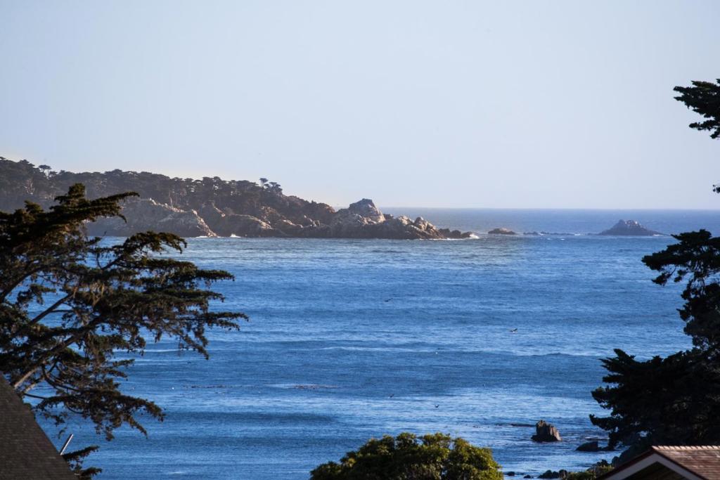 Arguably the most ideally located residence at the Pebble Beach Lodge across the street from the iconic arches leading to the 1st tee of the Pebble Beach Golf Course. Recently renovated and updated throughout, this oceanview luxury home is just steps to the world-class amenities at The Lodge and Beach & Tennis Club. There are spectacular ocean views from 3 terraces and most of the interior. Sliding glass doors flood the open concept kitchen, dining, and living room with an abundance of light. Enjoy views of Point Lobos, Carmel Beach, and the Peter Hay short course. The main level has no steps, 2 main bedroom suites plus a powder room. The residence includes a new attached guest house with separate entrance. Masterfully designed with 3 full size beds, a full bathroom, fireplace, second laundry room, dining area and kitchenette leading out to an ocean-view terrace with fire pit. There is also a full house generator, extra water credits, and approved plans for an additional 2-car garage.