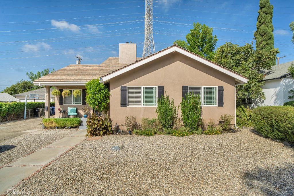 This stunning 4-bedroom, 3-bath, 2,024 sqft, two-story Northridge residence with detached, studio-style guest house, blends comfort, style, and modern upgrades in a warm, inviting space. Great curb appeal with clean, drought-conscious landscaping, decorative window shutters, and a cozy front porch. Inside the house offers effortless charm and thoughtful touches, including hardwood floors, recessed lighting, and plantation shutters throughout as well as modern comforts including dual pane windows, dual zone HVAC, and tankless water heater. Entry opens into versatile, open concept living space with flexible floorplan and room for both formal living and dining areas. The larger portion is anchored by a striking double-sided fireplace and flanking archways that lead into the bright, airy, informal living area, which shares the other side of the fireplace and has French doors out to the back patio, creating a seamless flow between the spaces. The remodeled kitchen is a showstopper, featuring striking, quartz counters, sleek contemporary cabinetry, herringbone glass tile backsplash, farmhouse sink, and high-end appliances with French door access to the back patio. The main floor offers a large secondary suite with beautiful bay window and en-suite full bath, as well as two stylish, sizable bedrooms which share an updated remodeled, full hall bath. Upstairs, in an adaptable loft space is the wonderful, airy primary suite. The spa-inspired primary bath is a sanctuary with a contemporary, dual sink vanity, freestanding soaking tub, oversized shower with multiple heads, and a barn-door entry, walk-in closet. The original detached garage has been thoughtfully converted into a flexible guest space (unpermitted) with a private entrance, vaulted ceiling, wood floors, kitchenette, and ¾ bath, ideal for extended family, work-from-home, or future rental potential, while the garage door remains intact for flexibility. Outdoors the design makes the most of the space with several covered patio spaces, a drought conscious turf lawn, and a separate storage/workshop space, ideal for entertaining or just relaxing. Well situated just minutes from CSUN, the Northridge Mall, and the treats at Porto’s Bakery, this home combines everyday functionality with stylish design and inviting comfort in one of Northridge’s sought-after neighborhoods. Don’t let this one pass you by!