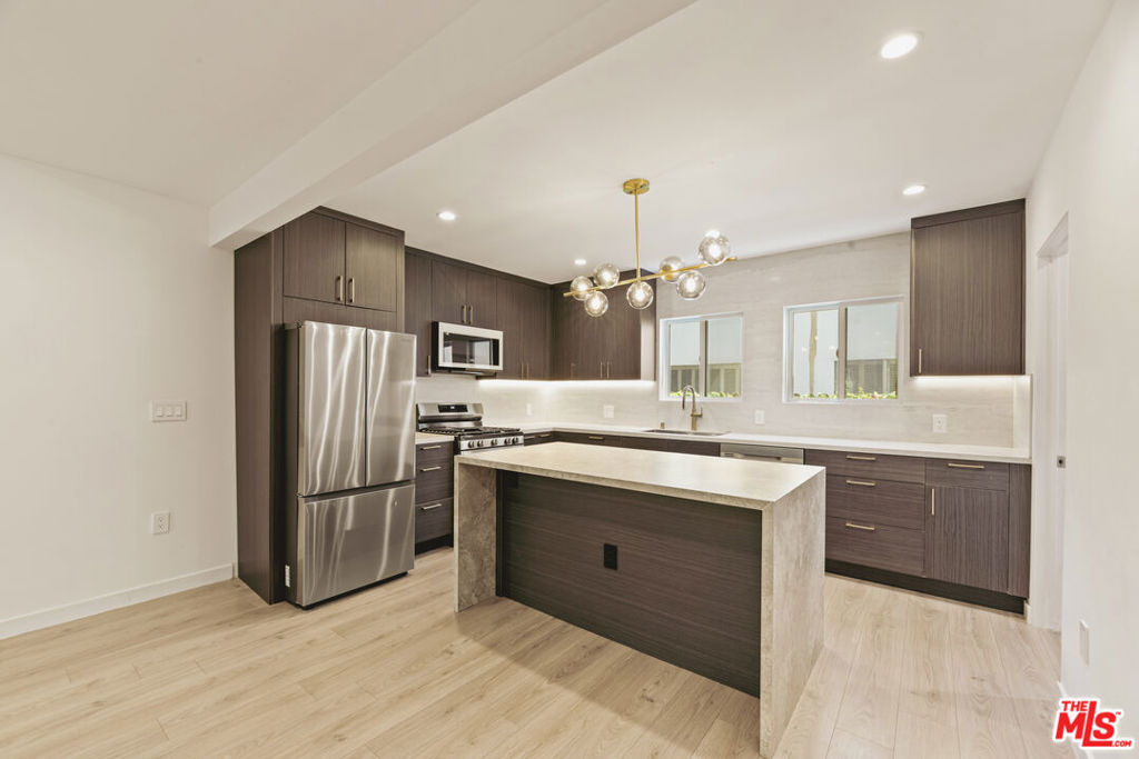 Welcome to 751 Alfred, a beautifully remodeled 2-bedroom, 1-bath apartment designed for modern comfort and convenience. The bright, open living area showcases new flooring and chic finishes throughout. The upgraded kitchen features sleek countertops, stainless steel appliances, and ample cabinetry. Both bedrooms are spacious and filled with natural light, each offering generous closet space. The bathroom has been thoughtfully updated with contemporary fixtures and a clean, modern aesthetic. The unit also features an in-unit washer and dryer. Nestled in a well-kept community with easy access to Melrose Place and West Hollywoods top shopping and dining, this residence truly has it all.