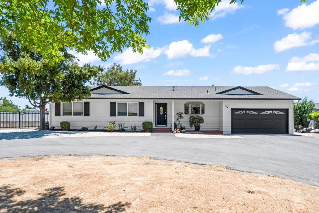 Welcome to your new hard to find one area parcel with great home in the charming city of Gilroy, offering a comfortable blend of modern amenities and cozy living. This spacious 1,912 sq ft residence features three bedrooms, including a primary suite/retreat, and updated bathroom equipped with an oversized tub and primary with stall shower. The kitchen boasts granite and tile countertops, complemented by quality appliances such as a built-in oven range, microwave, refrigerator, and dishwasher. Gourmet kitchen with quality rich cherry stained cabinets, granite counter tops, upgraded gas stove, Osmosis water system, Stainless steel appliances. Fresh exterior paint just done. Laundry is located in the garage with washer/dryer included. The home is situated within the Gilroy Unified School District, known for its community-oriented approach. Additional features include double pane windows, a garden window. Experience relaxed living in Gilroy. 22 different fruit trees, additional income non permitted studio rented for $1400/mo and trailer rented for $1300/mo. Great for extended family. To be vacant at closing. Horse permitted as per zoning, Great little farm house for all of your plantings!
