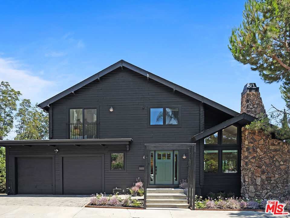 Nestled on a coveted flat street in Elysian Heights, this beautifully reimagined home blends the warmth of a rustic A-frame cabin with sleek, contemporary design. Spanning over 2,600 square feet, the light-filled interior welcomes you with soaring ceilings, an open-concept layout, and an abundance of natural light streaming through clerestory windows and skylights. The heart of the home centers around a spacious living and dining area, where a pitched tongue-and-groove ceiling and gas fireplace create an inviting atmosphere. The chef's kitchen, complete with integrated appliances, open shelving, and designer lighting, seamlessly connects to a cozy den. Designed for effortless entertaining, the Living Room and Kitchen open to a sprawling 1,800+ square foot deck overlooking the back yard, complete with a sparkling saltwater pool, rejuvenating spa, and firepit - perfect for evening relaxation or hosting under the stars. Inside, the home offers 4 bedrooms and 3 bathrooms, including a serene primary suite upstairs with dual closets and a spa-like bathroom featuring a soaking tub and dual vanity. Two additional bedrooms and a full bath complete the second floor, while a main-level bedroom and bathroom provide flexible living space for guests or a home office. A detached 172-square-foot bonus room adds even more versatility for work, creativity or exercise. Thoughtful upgrades, including Tesla solar panels, updated systems (sound and security), and newer HVAC, ensure modern efficiency. Located just moments from Echo Park's best hiking trails, Silver Lake Reservoir, Sunset Boulevard, and beloved local spots like Valerie, Cookbook and Canyon Coffee, this home offers the perfect balance of secluded tranquility and urban convenience. A rare opportunity to own a meticulously crafted retreat in one of LA's most enchanting neighborhoods.
