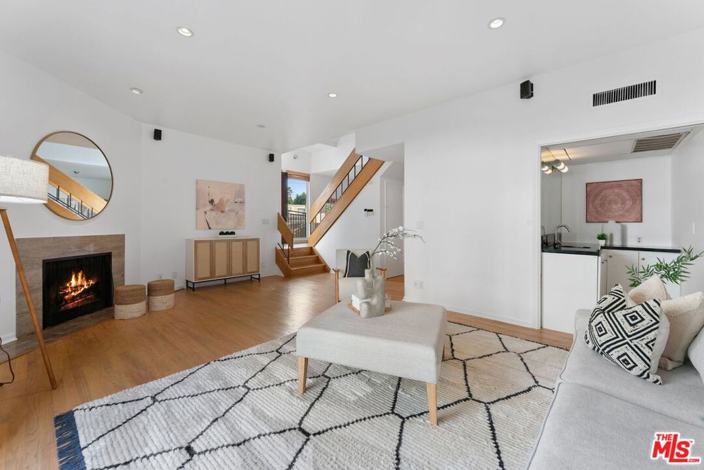 Welcome to this beautifully updated split-level condo in the heart of Brentwood. Situated in a boutique 4-unit building North of Wilshire, this light-filled 2 bedroom, 2.5 bath home offers a thoughtful layout and timeless style. The main level features an open living and dining area with ample windows that bring in natural light, a freshly painted interior, and wood floors that flow throughout the unit. The kitchen connects seamlessly to the dining space, making it perfect for both everyday living and entertaining. A spacious 2nd bedroom with its own en-suite bath completes the lower level. Upstairs, the private primary suite serves as a serene retreat with walk-in closet space and bathroom with soaking tub, separate shower, and dual sink vanity. Additional highlights include a guest powder room, in-unit laundry hookups, secure parking, and low HOA dues. With its prime location in a charming, intimate building just moments from Brentwood's shops, cafes, and markets, this home combines comfort, style, and convenience.