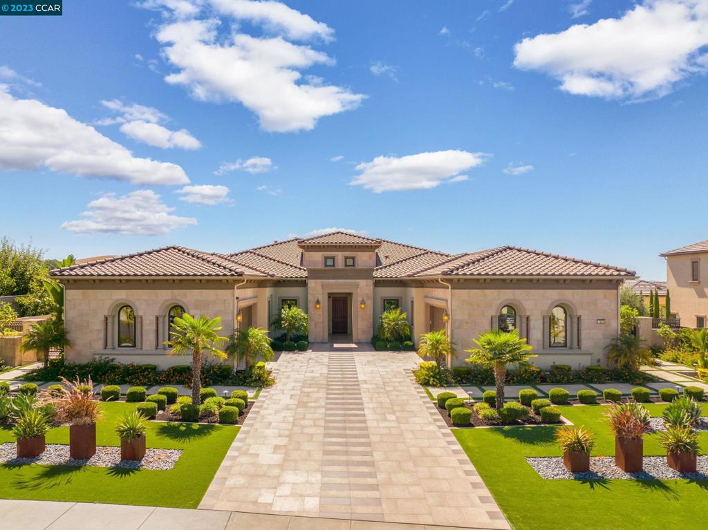 Stunning single-story home with volume ceilings. Conveniently located across from Blackhawk Country Club. Lot is over 2/3 acre, mostly flat, backing to view of hills & sunset. Blend indoor & outdoor living as the glass wall slides open from great room to loggia. Expansive grounds incl pool, spa, putting green, sports area, vineyard & four fire pits. Covered BBQ area features Lynx pizza oven & Heston grill. The indoor kitchen is a chef’s dream with Wolf & Sub Zero appliances, quartz counters, RH light fixtures, built-in espresso & more. Primary bedroom has a sitting area with sliding glass wall, dual closets & spa-like bathroom. Spacious guest suite has a separate entrance. Library is adjacent. The two other en-suite bedrooms are located perfectly next to a bonus room. Open floor plan has approx 4862sqft main house with 4 bedrooms, 4 ½ baths, library & bonus room. Plus approx 556sqft detached casita/cabana with full kitchen & bathroom (could be 5th bedroom). Tankless water heaters, multi zone HVAC, remote control blinds, apps for music & lighting. Solar owned electricity. 4 car garage (2+2) w Tesla charger.