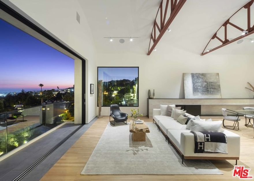 Steven Ehrlich, FAIA, 1988 & 2019. Steven Ehrlich reinvents his earlier version of this house as a thoroughly 21st Century entertaining compound. Broad entry stairs descend to a courtyard, a prologue to the copper-clad vault defining the main living/dining/great room. Glass sliding walls draw one to the view terraces overlooking the Village and Pacific Ocean. The horizontal hearth focuses on the unity of all 3 areas:  living room, dining area,& kitchen. Elegantly simple cabinetry of the kitchen blends seamlessly with the silken oak flooring throughout. The formal entry gives way to the generous family room/study & the adjacent powder room.The midlevel provides a transition area leading to the master suite w/ terrace and a guest bedroom w/ ensuite bath. The lower-level two-bedroom suite can function as a second master with sitting room/den, guest suite, or an entire entertaining area. Superior architecture and superior setting on a cul-de-sac minutes to the Village.