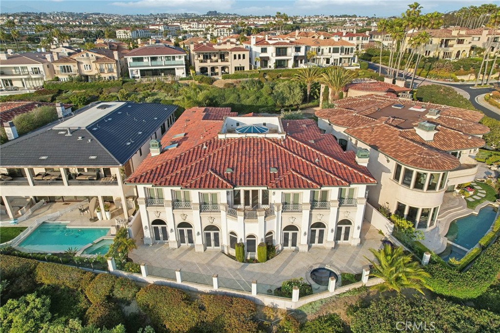 AVAILABLE FOR SHORT-TERM OR LONG-TERM LEASE -- FURNISHED OPTION AVAILABLE! CALL
Welcome to an extraordinary opportunity to lease a custom estate in the exclusive, guard-gated oceanfront enclave of Ritz Cove—one of Southern California’s most sought-after private beach communities. Perfectly positioned at the end of a quiet cul-de-sac, this stunning residence captures panoramic views of the Pacific Ocean and offers direct, private access to Salt Creek Beach, just steps away.
Built over three meticulous years, this architectural masterpiece boasts approx. 7,200 square feet of luxury living space on a 9,000+ sqft lot, featuring 5 en-suite bedrooms and 6.5 baths. A dramatic entry with a sweeping staircase, domed skylight, and crystal chandelier opens to immediate, unobstructed ocean vistas that set the tone for the entire home.
The main level is designed for both grand-scale entertaining and relaxed coastal living, complete with an ocean-view living room, formal dining area, family room, “poker room,” and an exquisite library/study wrapped in rich woodwork, with its own private bath. A gourmet kitchen with a butler’s pantry, sunken wet bar, and top-tier appliances enhances the home’s sophisticated charm.
Upstairs, all bedrooms feature en-suite baths and walk-in closets. The ocean-facing primary suite is a private sanctuary with a cozy sitting area, fireplace, view terrace, dual walk-in closets, and a spa-like marble bath. Additional highlights include a private spa, exterior beach shower, elevator, four-zone HVAC, and an oversized three-car garage ideal for collectors.
As a resident of Ritz Cove, you’ll enjoy 24-hour guarded security, a serene and private coastal setting, and direct gated access to the beach. Walk to the luxurious Ritz-Carlton and Waldorf Astoria resorts or explore the nearby Dana Point Harbor, Montage Laguna Beach, and endless shopping and dining options.
This is coastal California living at its finest—where privacy meets the Pacific.