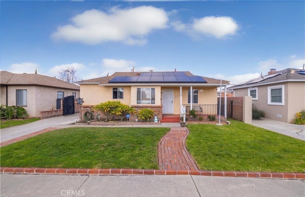 Welcome to your cozy retreat in the heart of Downey! This charming three-bedroom home features a recently remodeled bathroom and an open-concept living room with a fireplace that flows seamlessly into the dining area, filled with natural light. Step outside to a backyard designed for relaxation and entertainment, complete with a sparkling pool and spa.
The home comes fully equipped with paid-off solar panels and an electric vehicle charger—keeping energy costs low and efficiency high. A long driveway provides plenty of extra parking, along with a detached two-car garage. Ideally located near shopping, dining, schools, and with easy access to the 605 and 5 freeways, this home truly combines comfort, style, and convenience.