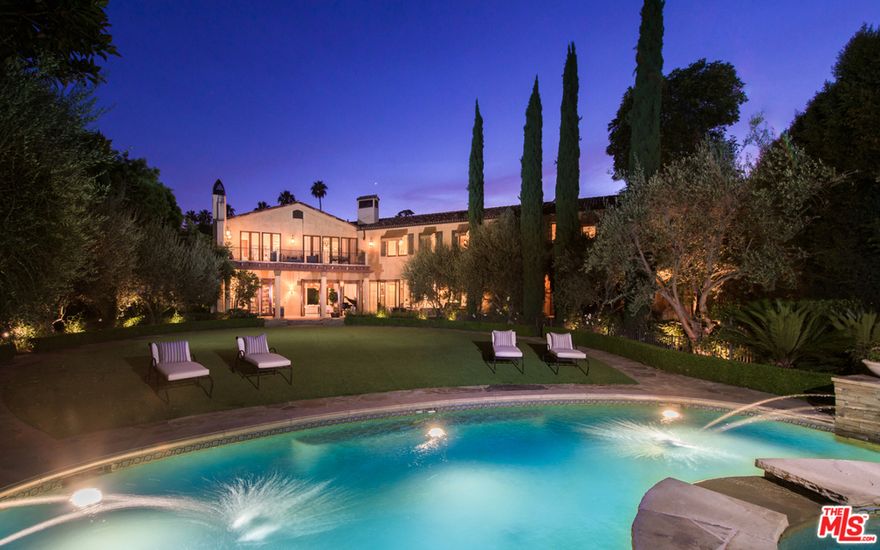 Tucked behind private gates & tall hedges, this timeless Mediterranean estate is set on a coveted large corner lot in exclusive Brentwood Park offering unparalleled elegance throughout. This gracious estate has a park-like feel with expansive lawns, mature trees & picturesque gardens. Formal entry with beautiful curved staircase leads to a chef's kitchen with top-of-the-line appliances, French doors leading to access to the open patio & backyard. Main level spaces feature a great room, formal dining room, sitting room, bedroom, office & bar. Upstairs are four spacious en-suite bedrooms with walk-in closets, movie theater & an additional great room with built-in cabinetry. The master bedroom suites offers a sitting area, mezzanine overlooking the backyard, private office & his and hers luxurious bathrooms. A billiards room, elevator, 3 car garage, swimming pool and spa completes this spectacular trophy property.