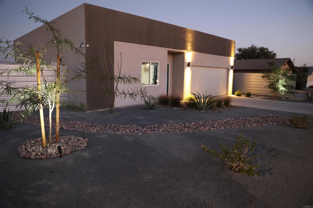 Explore this exquisite, newer built home with deluxe comforts and designed for the ultimate desert retreat in style. Just 15 min from Palm Springs and close to acclaimed spas and hot springs, it's also within 30-45 min to Coachella and 35 min to the wonders of Joshua Tree. A modern design and an open floorplan, the kitchen features stainless steel appliances, quartz countertops and bar seating. Enjoy the convenience of an In-home, side by side washer and dryer, along with a spacious 2-care garage, complete with Electric Vehicle charging station. The gorgeous backyard is perfect for relaxing and entertainment. Enjoy sitting around the cozy firepit, relaxing in the hammock, dining al fresco, a putting green and marveling at the gorgeous city/mountain views in the hot tub.