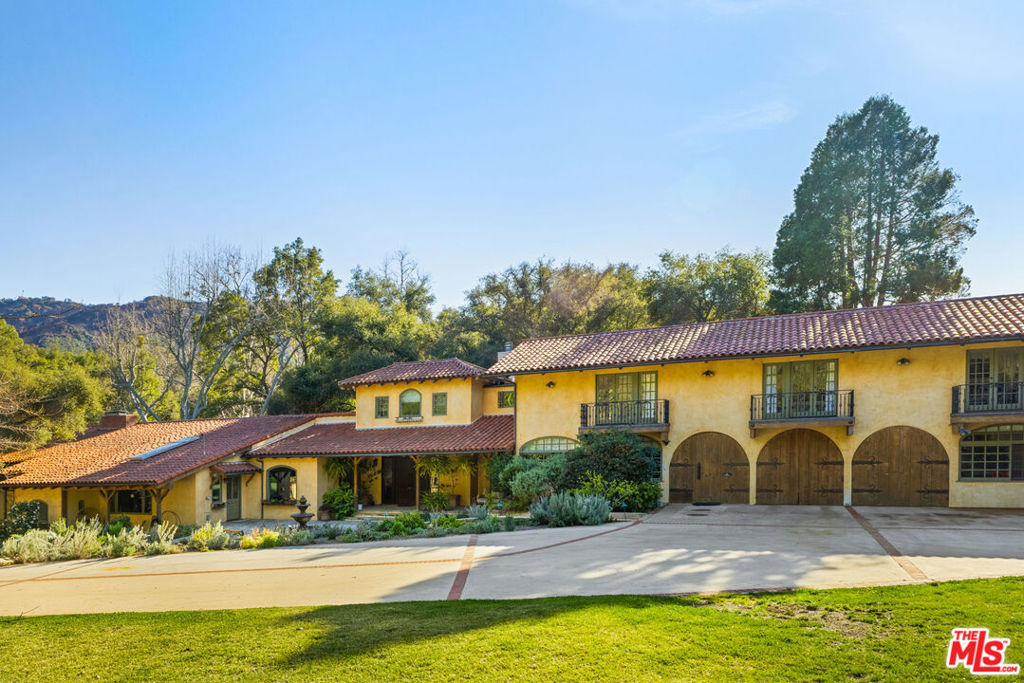Welcome to 821 Camino Colibri, a breathtaking Monte Nido Luxury Ranch set in a serene and private oasis just minutes to Malibu and trendy Calabasas. Just over the lovely Edenwild bridge, this unforgettable equestrian estate offers a unique blend of tranquility and luxury on nearly 4.5 acres of oak studded park-like grounds, with glorious mature trees and gardens, and bordered by a remarkable seasonal creek. The property features an ancient oak grove, open pastures, two arenas, stalls, and a horse barn, making it a perfect retreat for equestrian and nature enthusiasts. Step inside this gorgeous Spanish estate and be captivated by this spacious and newly remodeled home, offering approximately 6,082 square feet. With 5 bedrooms and 6 beautifully remodeled bathrooms, there's ample room for family and guests, completed by a fully equipped detached 1 bedroom 1 bath apartment. The chef's kitchen is a culinary dream, featuring top-of-the-line Viking and Sub Zero appliances, perfect for crafting gourmet meals. The home's interior boasts a vaulted ceiling family room with an impressive wood-burning fireplace that opens to a wrap-around veranda. This overlooks the inviting pool area and horse arena, providing a picture perfect backdrop for relaxation and entertainment. For movie lovers, the large home theatre is an ideal spot to unwind. The home also features two private work spaces, with dramatic views of the enchanting landscape. The beautiful hacienda-style fireplace and BBQ center is ideal for outdoor entertaining and stargazing opportunities. Imagine entertaining guests while overlooking the expansive lawns and listening to the soothing sounds of frogs and crickets from the seasonal stream. The property also includes a variety of fruit trees, vegetable gardens, a green house, and majestic mountain views, all within the total privacy of your gated estate. Enjoy easy access to the surrounding Santa Monica mountains' trail system right outside your front door for glorious hiking and trail riding. This Monte Nido haven offers an unparalleled lifestyle, combining luxury living with the beauty of nature. Don't miss the opportunity to make this exquisite estate your home. Award winning Las Virgenes Schools and mins to Viewpoint School. This IS California living and dreaming at it's best!