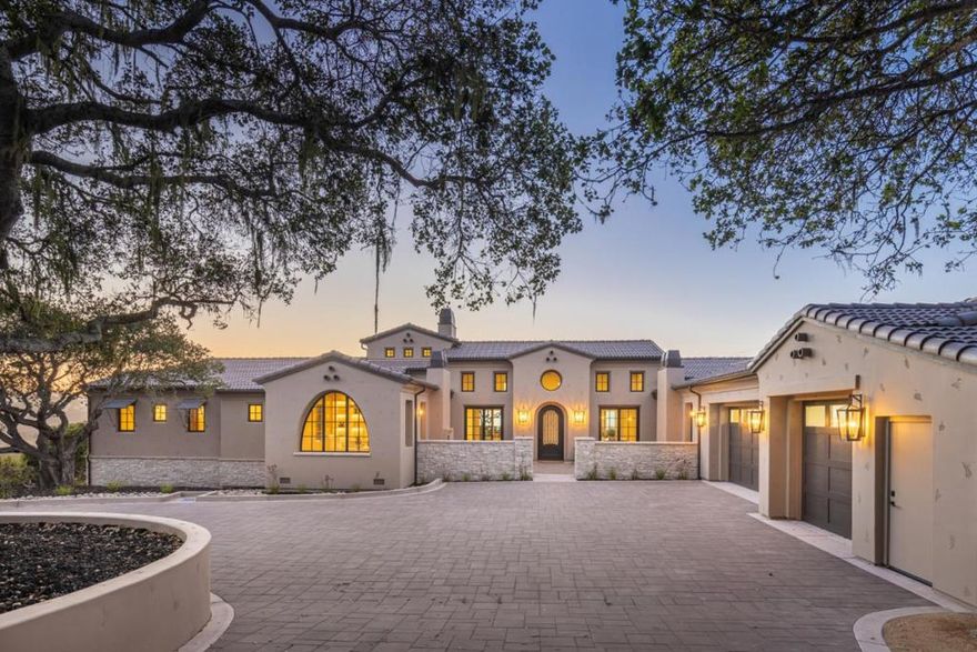 Nestled on a coveted street in Monterra, 8220 Manjares is a newly built custom home offering elevated coastal living. Set on a premier view lot surrounded by majestic oaks and sweeping bay views, this 5,800 sq ft masterpiece blends timeless sophistication with designer details. A private courtyard with an outdoor fireplace welcomes you to the home, leading to a grand, light-filled great room that opens onto a spacious balcony to capture the stunning views. The chefs kitchen features leathered quartzite countertops, Thermador appliances, and a large center island, perfect for both cooking and entertaining. The main-level primary suite is a serene retreat with its own fireplace, spa-inspired bathroom, and expansive closet. Downstairs offers three ensuite bedrooms, a family room, wine cellar, and second laundry area. Equipped with smart home technology, this property represents the finest in comfort, design, and craftsmanship. A rare opportunity for Monterra luxury living.