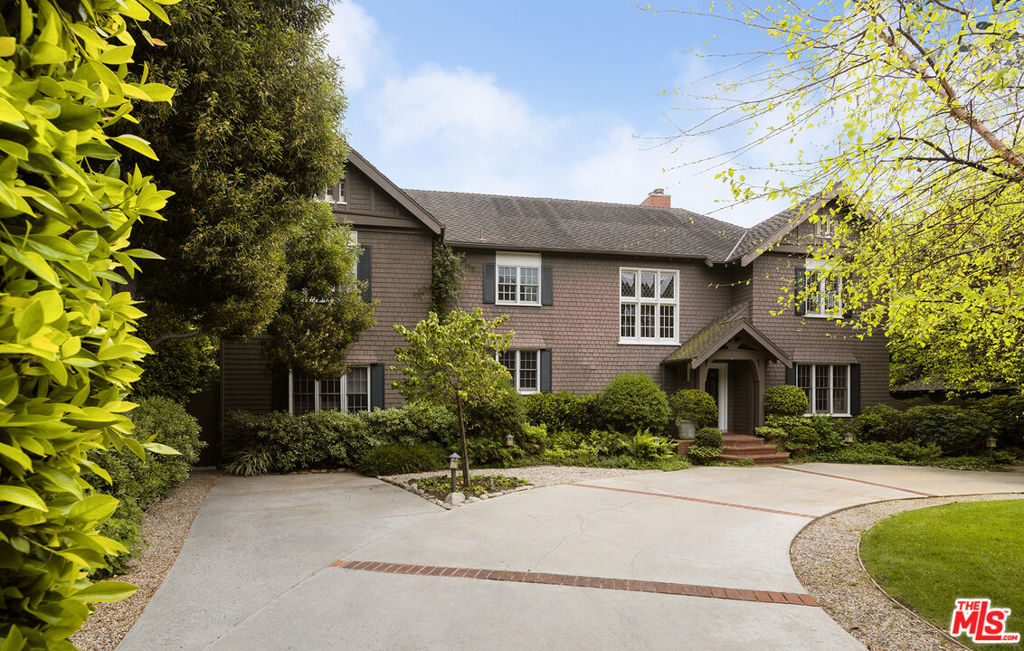 Exceptional East Coast traditional storybook residence on a sprawling triple lot located in the most highly coveted Santa Monica neighborhood, North of Montana, less than a block away from Santa Monica's Gold Coast Beach and Palisades Park. Originally constructed by renowned architects Greene and Greene in 1917, this fully renovated, truly remarkable American shingle abode is completely one of a kind, unlike any of their other work. The expansive main residence welcomes in bright sunlight through charming windows and French doors capturing views of the lush, sprawling yard. The main level showcases a traditional living room with custom built-ins and window seats, elegant formal dining, a vast family room, and one of the 5 bedrooms. The second level boasts the additional 4 sizable bedrooms in the main home including a considerable primary suite with luxurious en-suite and substantial walk-in closet. An inviting playroom is located on the third level. This flat half acre plus lot offers an ample brick-paved, horseshoe driveway, a vine adorned two-story A-Frame music studio used by notable artists Jackson Browne, Daryl Hannah and Emmy Award winning John Bowman, a two Bedroom Guest House with full kitchen and bath, generous pool and spa, fire pit, pickle ball & paddle tennis court, a built-in outdoor grill, multiple entertaining decks to enjoy indoor-outdoor living and a rose garden, all fully enclosed by 30 foot hedges and mature trees. Gravel paths and an abundant grassy pad, that has hosted countless games of croquet, complete this idyllic, ultra-private lot. Remarkable opportunity to reside in this history-rich, admirably crafted masterpiece.
