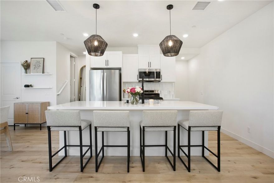 Welcome to the beautifully designed town home located in the Hudson gated community of Placentia. Newly built at the end of 2022 with an inviting open floor plan that features upgraded luxury vinyl flooring, high ceiling, recessed lighting throughout the home, dual-pane windows and sliding door that leads to the balcony, perfect for outdoor sitting, a walk-in pantry to store snacks, kitchen island with quartz countertop equipped with a single bowl sink and tiled marble back splash offering a clean aesthetic to the white shaker cabinetry matching cohesively with powder room. This turn-key home was thoughtfully built for energy efficiency featuring solar panels, a tank-less water heater, enhanced insulation. Enjoy the convenience of smart home features - garage opener, connected thermostat and smart door. Located on the third floor you'll find all generous sized bedrooms, laundry area and a linen closet. Primary bedroom features a walk-in closet, en suite bathroom includes a step in shower with glass, tiled flooring, quartz counter top. Two-car garage, direct entry with plenty of space for storage. Community offers, BBQ area, fire-pit to hang out, Playground for tot lot, Basketball Court and Dog Park. Conveniently located near shopping centers, restaurants, 91/55/57 freeways and walking distance from schools.