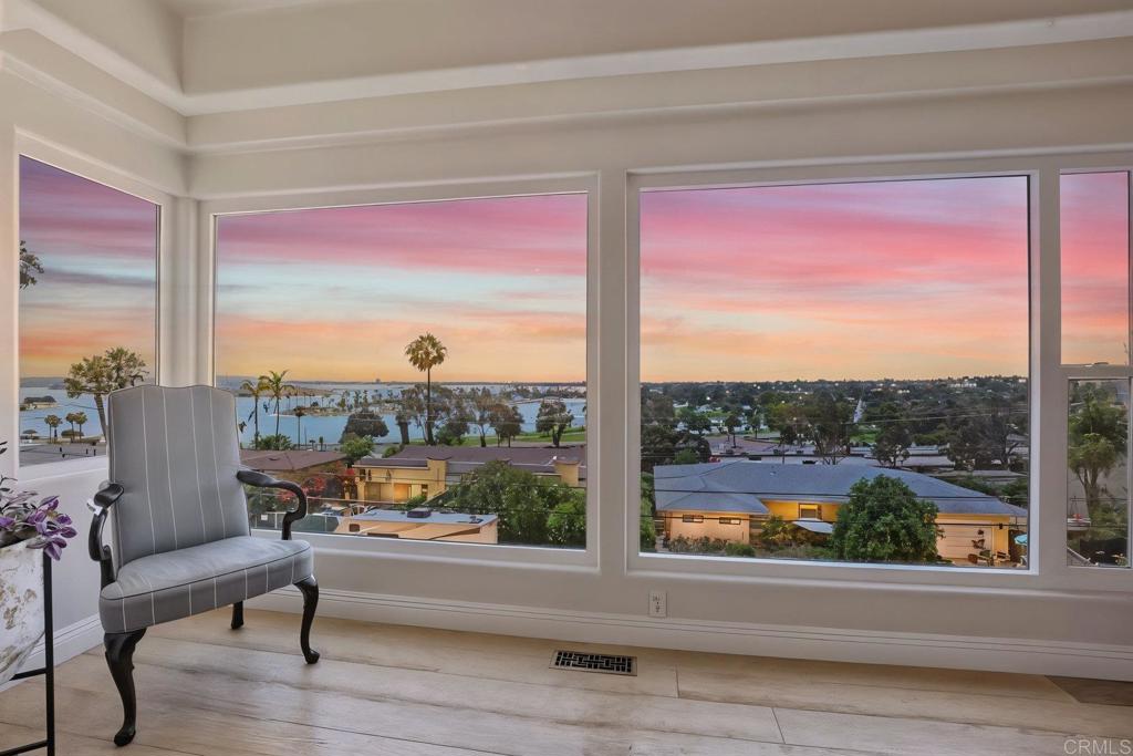 Stunningly Updated Bay Park Home with Panoramic Views! This gorgeous open concept home flooded with natural light and ocean breezes is a must see, perched high above the coastline in San Diego's coveted Bay Park neighborhood. Watch boats in the bay, entertain family and friends with your sweeping panoramic views, and enjoy amazing sunsets or watch fireworks under the stars. Prime location with breathtaking vistas that will take your breath away every single day! As you enter the flowing floor plan, you cannot miss the high end updates that shine throughout the home with serene views from every room! Thoughtfully designed to maximize views, functionality, and comfort, everything has been updated with designer finishes and the utmost care. Beautiful wide plank engineered hardwood flooring, a premium upgrade from luxury vinyl plank, flows seamlessly while modern ceiling fans and designer stone fireplaces create the perfect ambiance. The newly remodeled and expanded chef's kitchen showcases stunning quartz countertops, large undermount sink with instant hot water, designer soft close cabinets, premier Blue Star stove with Vent-A-Hood range hood, and Wolf and Bosch appliances. A spacious walk-in pantry provides ample storage for all your culinary needs. The guest bathroom features a floating vanity with porcelain wood plank tile, while the guest room/office offers access to the backyard through elegant French doors. The spacious main level room includes an en suite travertine and granite bath with even more spectacular views! Retreat upstairs to the newly remodeled master suite and spa with luxury touches at every step. Wake up to breathtaking views of the bay - even the new walk-in frameless shower has a window with a tranquil view! The master retreat features Carrara quartz wet bar with wine fridge and newly remodeled quartz fireplace. Dual quartz vanity with Rohl fixtures, Victoria and Albert luxury soaking tub with handheld wand, and a pebble stone shower floor provide ultimate luxury and relaxation. Enjoy a glass of wine on your new Trex deck watching the boats go by and lights of SeaWorld! Expansive windows, walk-in closet, and spacious sitting area complete this stunning sanctuary. A spacious detached bonus room with panoramic views offers endless possibilities - perfect for work space, artist studio, fitness room, yoga retreat, or guest house with electric and water line already installed. The large outdoor space features grassy area, eating area, and lush tropical landscaping with a Eureka lemon tree. Additional highlights include 2 skylights, garden boxes, recessed lighting, crown molding, new hardware throughout, electric sunshade, all new closet doors, new windows, designer window coverings, Australian screen doors, and surround sound throughout. Lime, orange, and lemon trees along with beautiful palm trees, plumeria, and hibiscus creating your own tropical paradise. You will love this extraordinary turn-key ready home in a perfect location! Minutes to the beach and Mission Bay with fantastic dining, coffee shops, and shopping all nearby. Watch the fireworks from your patio with easy freeway, Coaster, and trolley access - you're never far from all that San Diego has to offer! Moments from downtown, this property is ideal for those seeking the ultimate coastal lifestyle. Whether biking to the beach or strolling to the bay, your dream home with unparalleled views awaits in Bay Park!