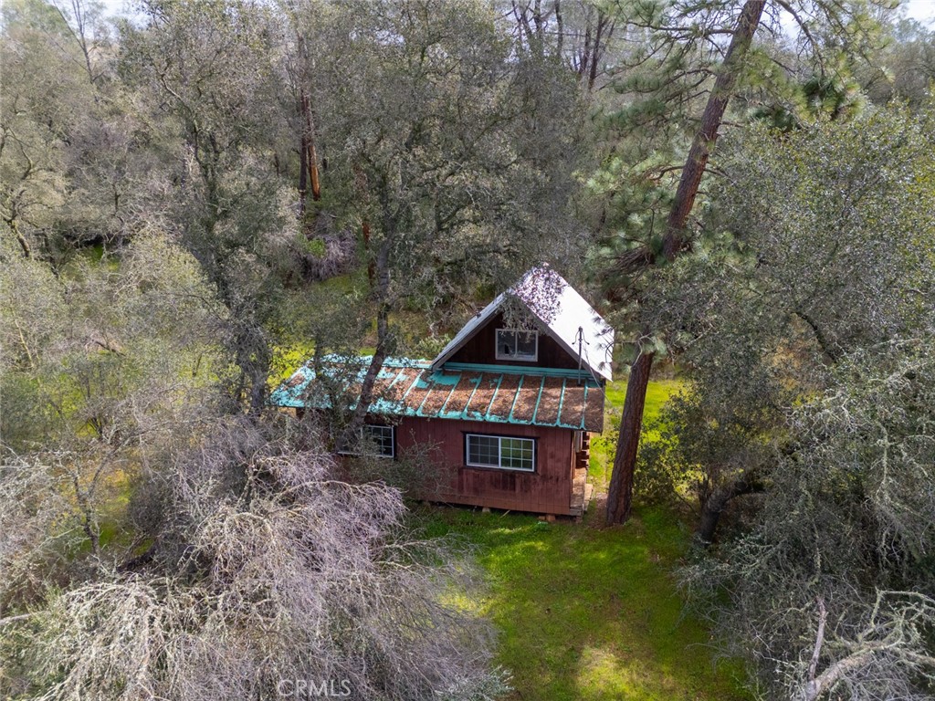 Beautiful secluded 10+acre property available to build, existing cabin structure is across the bridge beyond the creek, septic or well are unknown buyer to verify with county records. There is an electrical pole on the front of the property, new owner will need to run electricity to it.