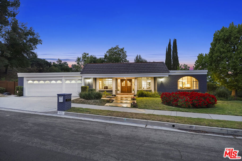 Style, form and function come together beautifully in this stately Lake Encino Hollywood Regency, nestled high in the hills in one of the most sought after neighborhoods, South of the Boulevard, in Encino. Private, peaceful, serene with updates that reflect the design and amenities ideally suited for today's contemporary living. Embodying a unique style with a polished sophistication, the exterior presentation is picture perfect with verdant, distinctive grounds, handsomely appointed front and back with floral and greenery. Through double doors vast open spaces are casually elegant and airy with a soothing, neutral palette. Abundant, natural light pours in from a multitude of glass with picture frame windows showcasing boundless mountain, canyon and nature views at every turn. Modernized baths are dressed in fine lighting, fixtures and finishes. Finely curated for the adventurous at home chef, the epicurean, eat in kitchen is artfully adorned with an array of top of the line stainless steel appliances including a 6-burner Wolf range and Subzero built-in fridge. Designed for entertaining, the formal dining room lends itself ideally to friend and family gatherings of all occasions. Bridging the aesthetic divide between structure and nature, glass sliding doors throughout bring the outdoors in and give way to an ultra-private, easy maintenance and eco-friendly back yard and patio, perfect for the Southern California lifestyle of relaxed al fresco leisure and endless outdoor entertaining. Five well-proportioned bedrooms including a lux primary suite round out the comfortable accommodations. Highlights include a full service bar and direct access 3-car garage. Residing on a tranquil, picturesque near 1/3 acre corner lot in the Nestle Avenue Charter School District and just moments from the chic shopping and dining district along famed Ventura Blvd. This residence of timeless style and enduring appeal is the place and space where you want to live. Welcome!