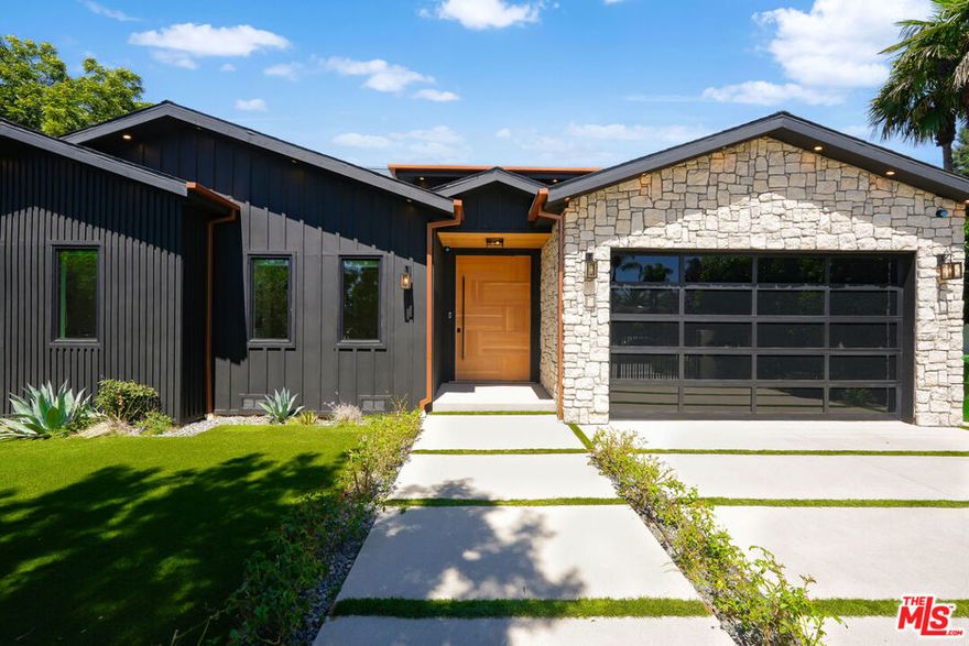 This fully renovated 5BR/4.5BA single-story home in coveted Chandler Estates offers 3,600 sq ft of refined living space on a prime corner lot. The open floor plan features a chef's kitchen with custom cabinetry, high-end appliances, and a large center island. A spacious dining area with wet bar and a dramatic family room with vaulted wood ceilings and stone fireplace create a warm, elegant atmosphere.Seamless indoor-outdoor flow leads to a private backyard oasis with a cabana, fireplace, pool/spa with waterfall, and built-in BBQperfect for entertaining. The luxurious primary suite includes vaulted ceilings, stone fireplace, walk-in closet, and spa-inspired bath.Custom finishes, smart home technology, surround sound, and a full security system complete this exceptional offering in one of Sherman Oaks' most desirable neighborhoods.