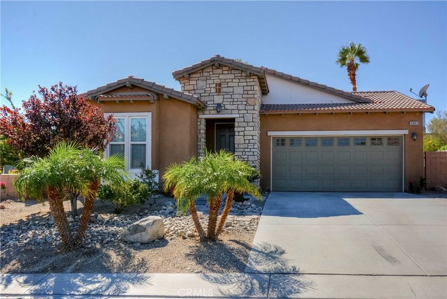 Discover this stunning SINGLE STORY home nestled in the sought-after Skyborne community of Desert Hot Springs. The residence features three bedrooms, two and a half bathrooms, and a two-car garage. The flex room is being used as a dining room and it can be also used as a living room or an office, while the expansive kitchen boasts elegant granite countertops, a large island with bar seating, ample cabinet space, and a built-in desk. The kitchen flows into the family room, complete with a cozy fireplace, ideal for family gatherings. Enjoy recessed ceiling lights, ceiling fans, high ceilings, premium tiles thru out the house. A French door leads from the kitchen to the backyard. The primary suite includes a spacious bedroom, walk-in closet, and a bathroom with dual sinks, a separate walk-in shower, and a bathtub. Two additional well-proportioned bedrooms are included. The covered patio offers additional space, perfect for outdoor entertainment. The laundry room's convenient location near the garage adds to the home's thoughtful layout. Drought resistant backyard with solid patio cover. Skyborne community amenities enhance the living experience with a community pool, BBQ areas/parks, a dog park, and private gates. Close proximity to Palm Springs, restaurants, shopping, casinos, and entertainment.