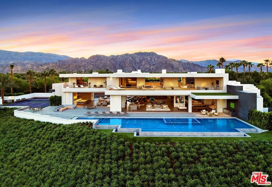 Exquisite, exceptional and explosive. Panoramic mountain, water and golf views embrace this one of a kind warm and stylish resort-like contemporary inside the Madison Club. Located on the best street in the famed club and perched high above the most beloved 8th fairway, sensational views are everywhere including from the championship pickleball soft court. Hotel scale with 21,455 SF under roof (15,874 under AC) including a game room, gym, cinema, chef kitchen, multiple fire pits and water features and a total of more than 20 different seating and lounging areas on the first floor alone. Beautiful, natural and original custom interiors with a world class designer's touch all framed by magnificent abstract art and merging with the mature landscape and breathtaking views.